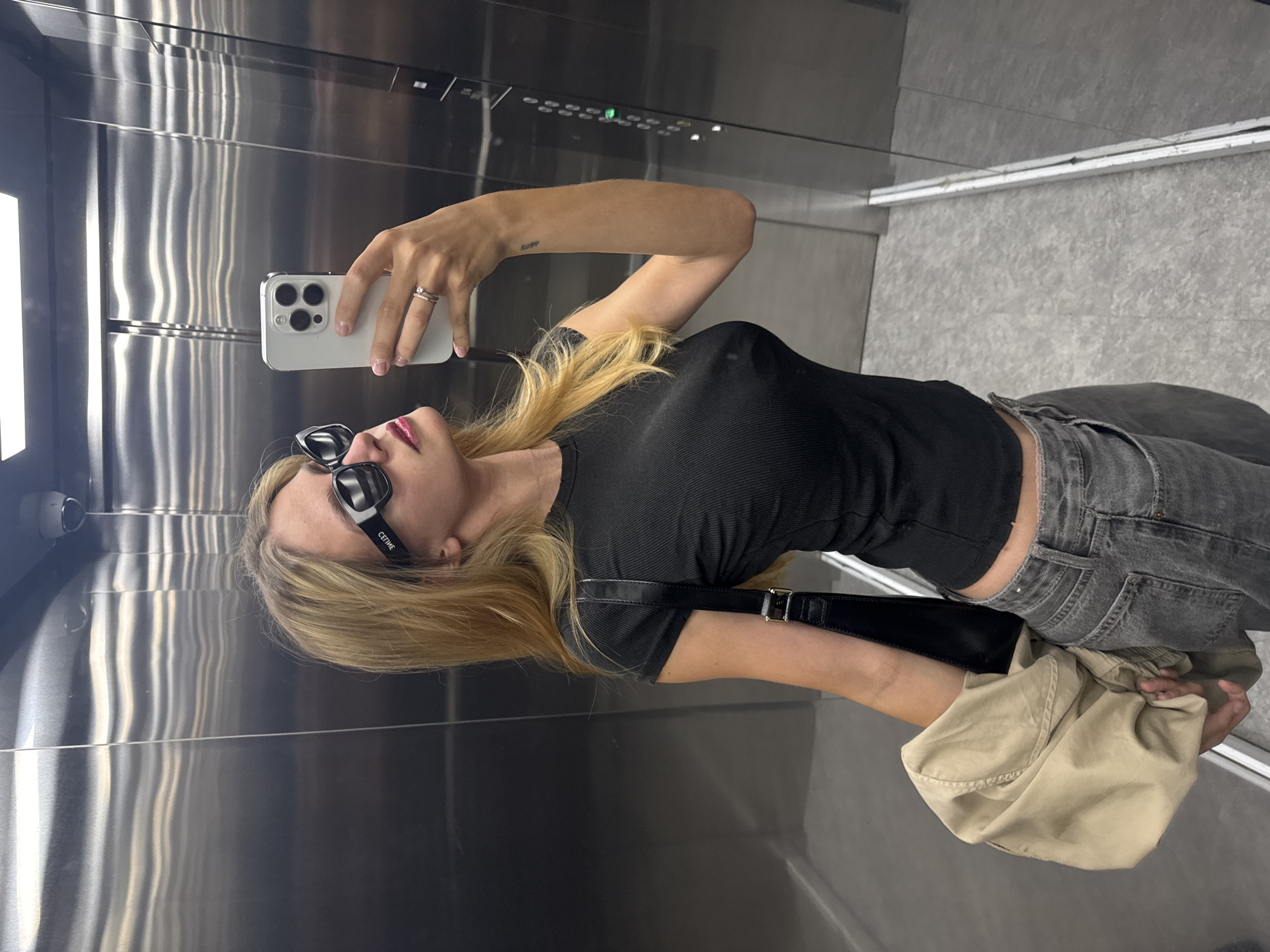 Woman Takes Elevator Selfie in Steel-Walled Lift