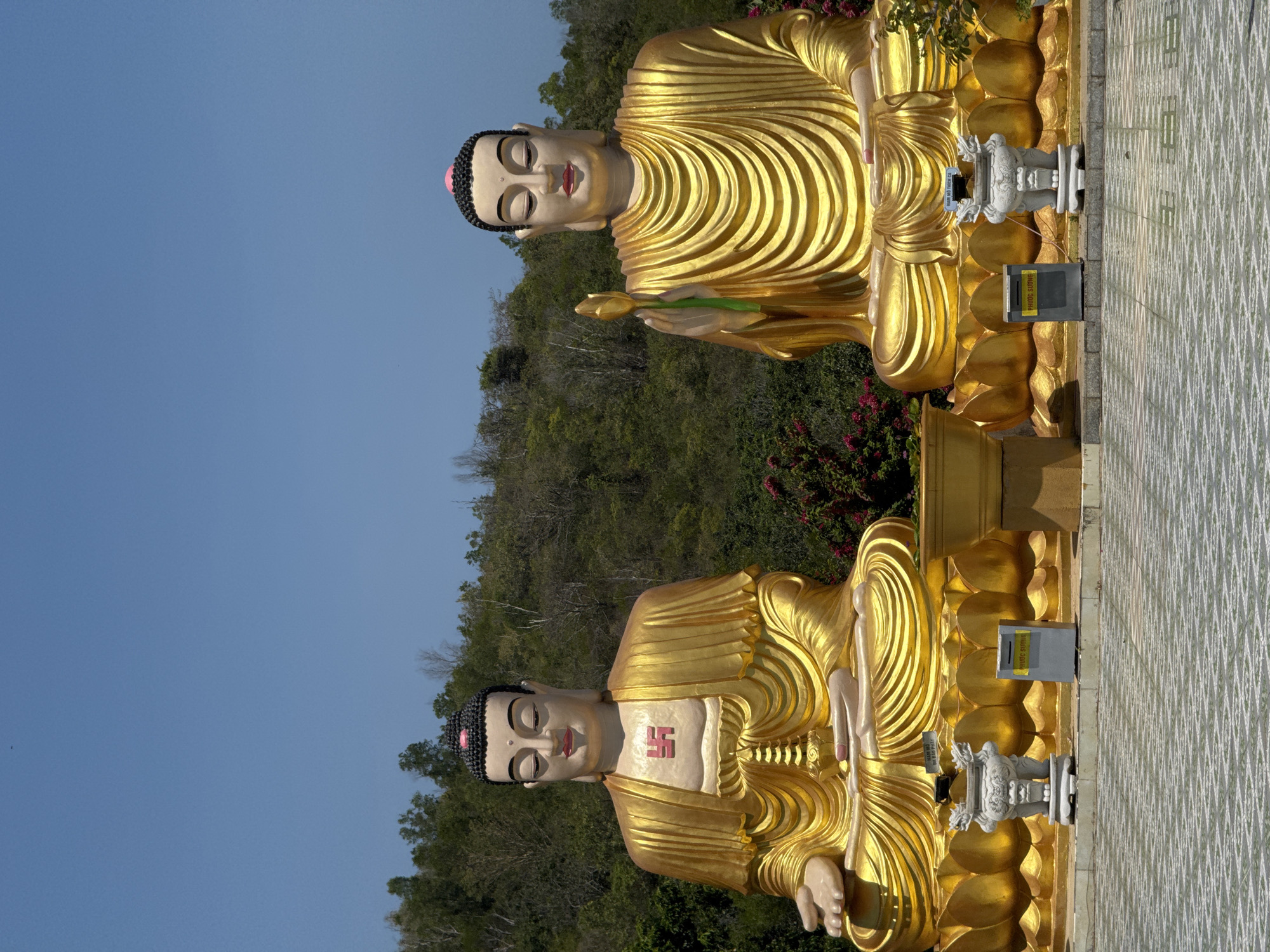 Golden Buddha statues photographed at Vietnamese temple shrine