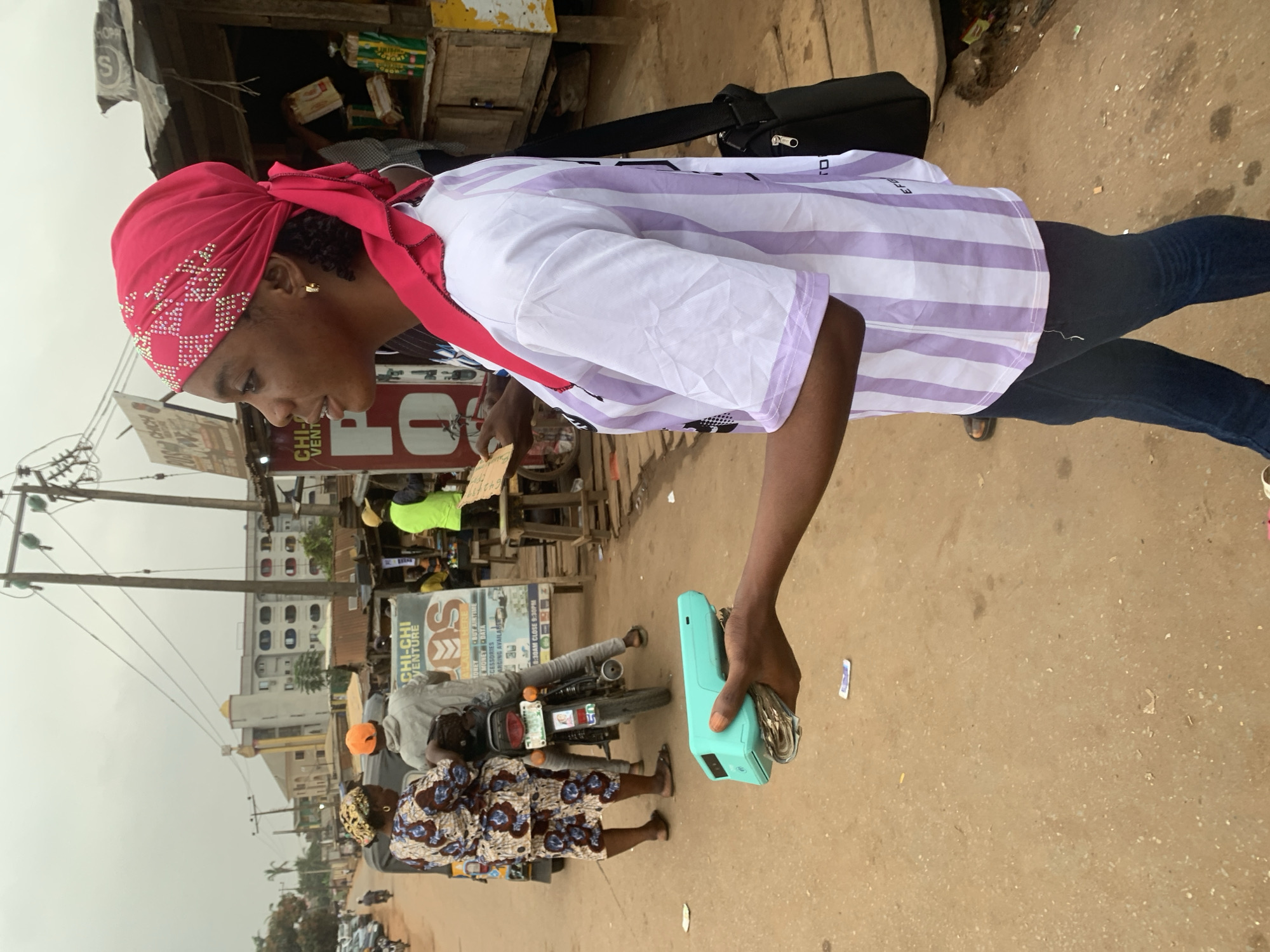 Street commerce and daily movement on a dusty Shagamu road