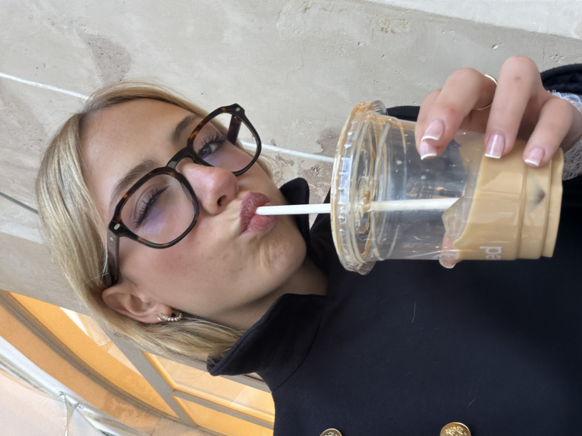 Woman takes selfies while café-hopping in Paris