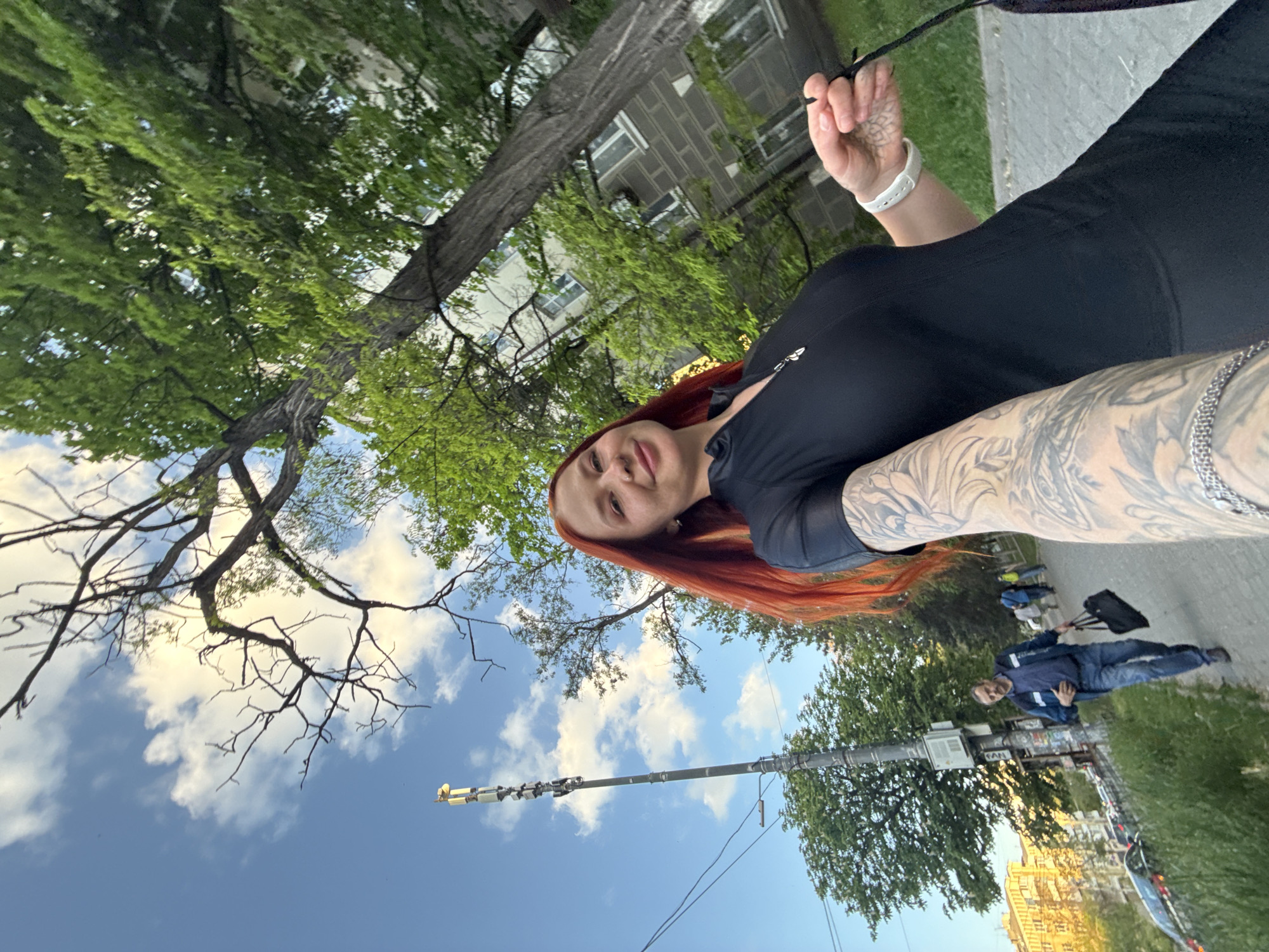 Tattooed woman takes selfies on Rostov-on-Don sidewalk