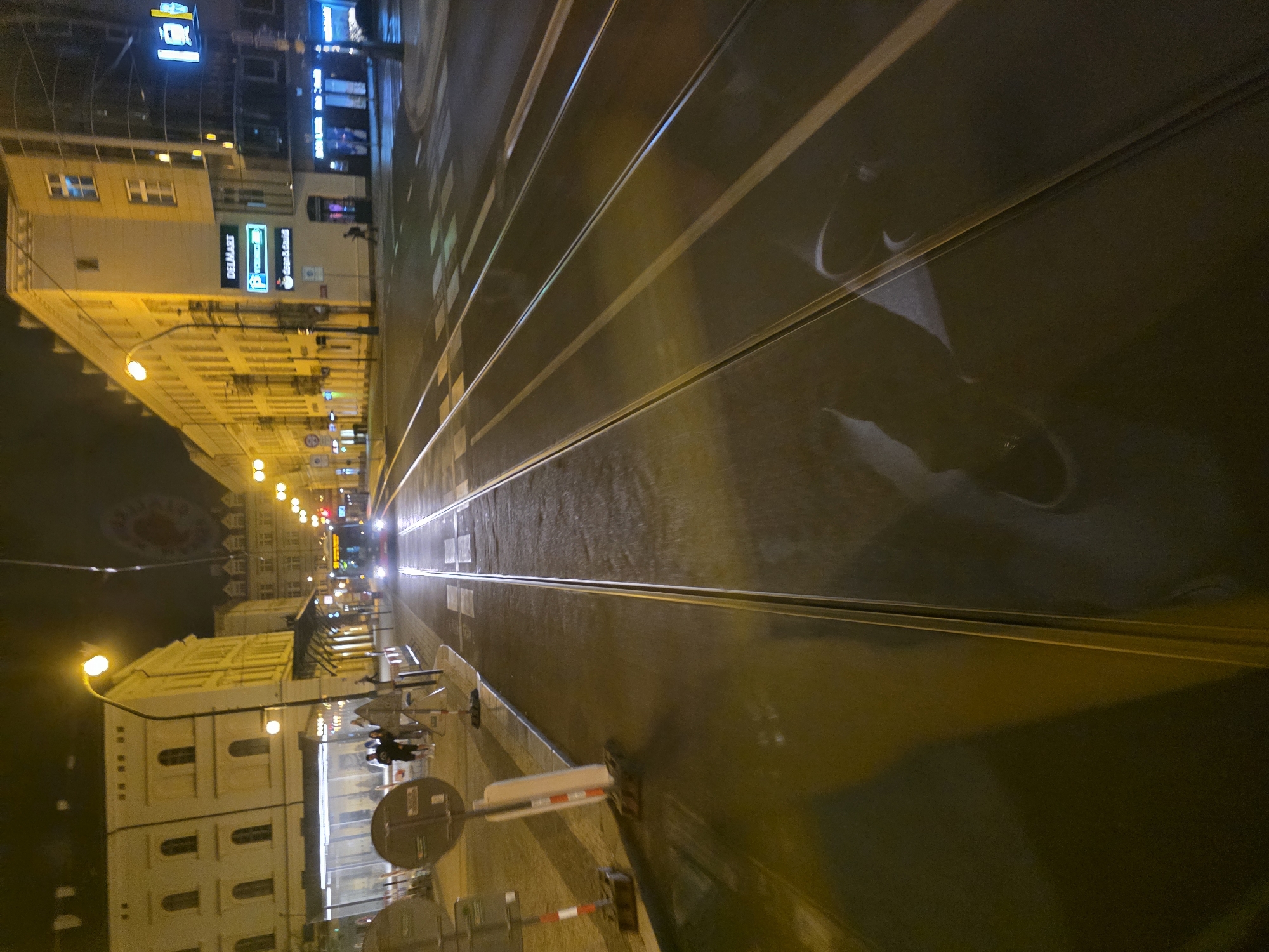 Nighttime tram journey through illuminated city streets documented