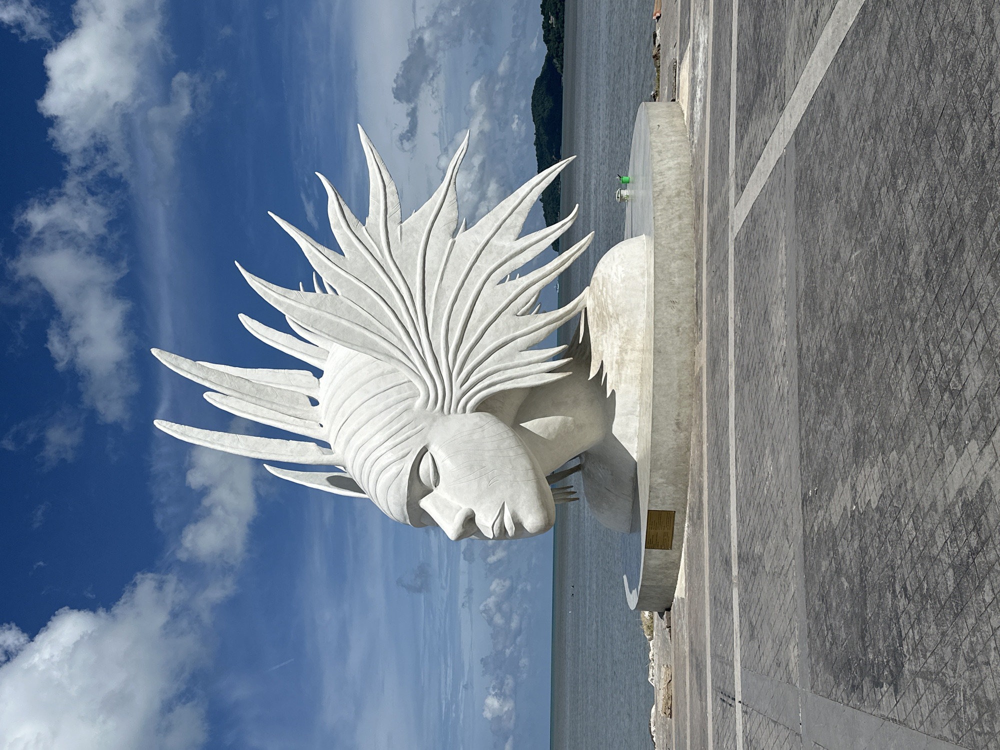 Phuket landmarks: sculptures, tourist signs, and a shipwreck