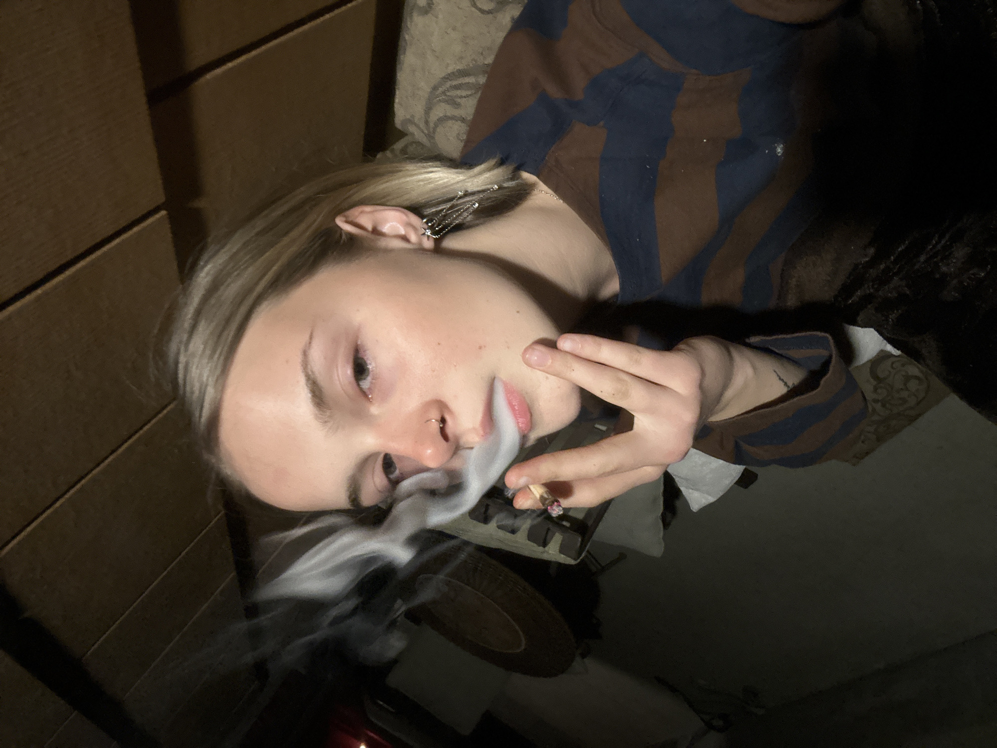 Woman smoking cigarette indoors in Whistler early morning