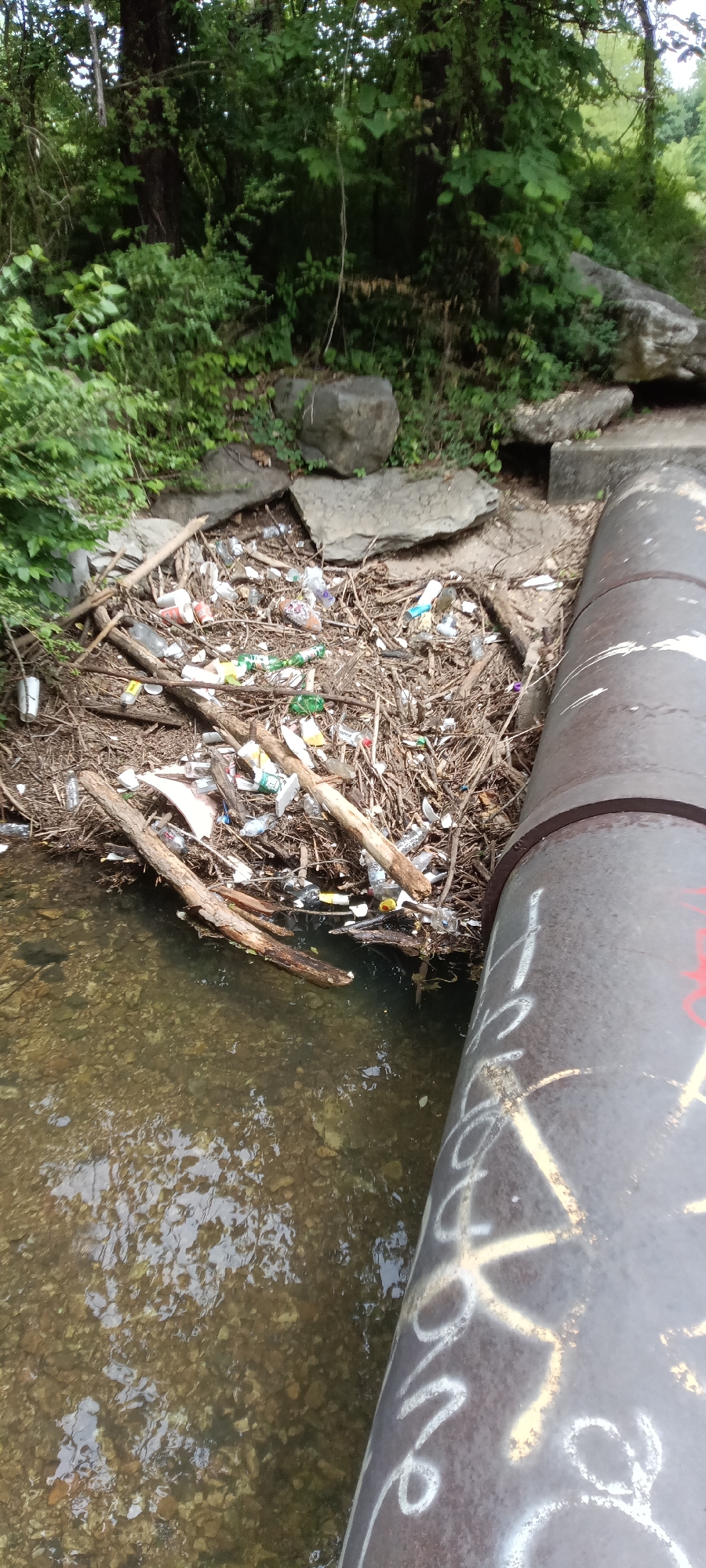 Creek conditions documented in Tahlequah showing debris and infrastructure