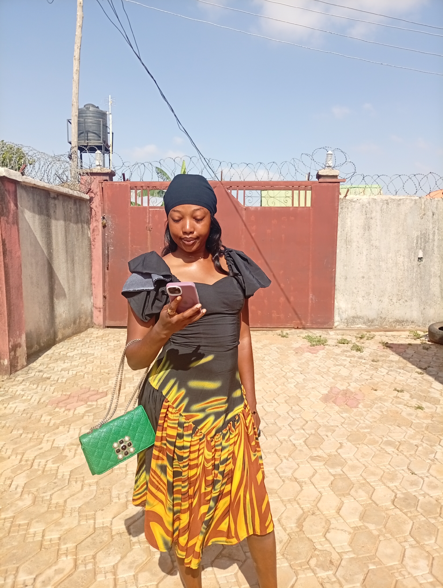 Women check phone on street in Rido, Nigeria