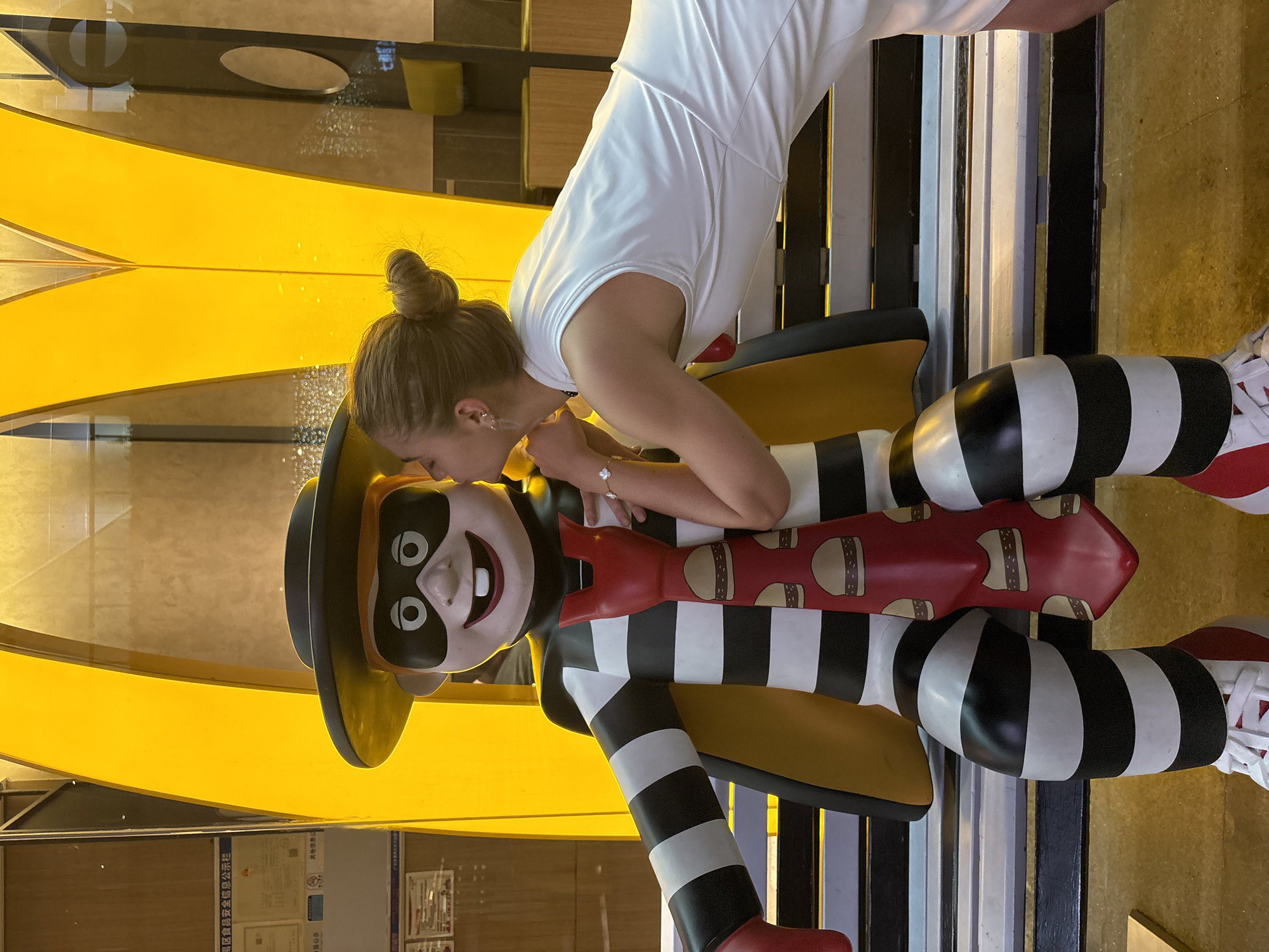 Woman poses with McDonald's displays in Panyu District