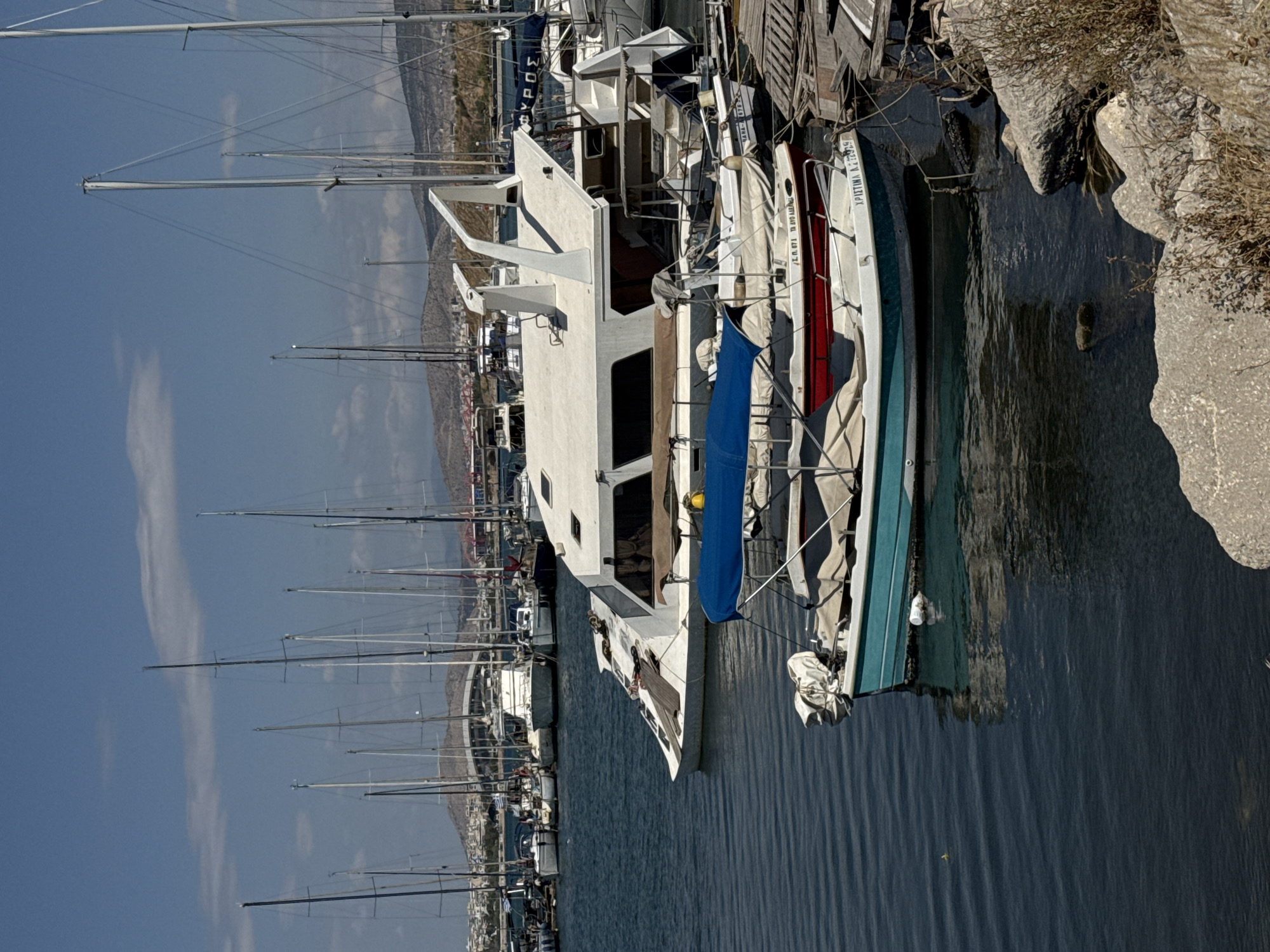 Sailboats moored at a sunny Piraeus marina, July morning