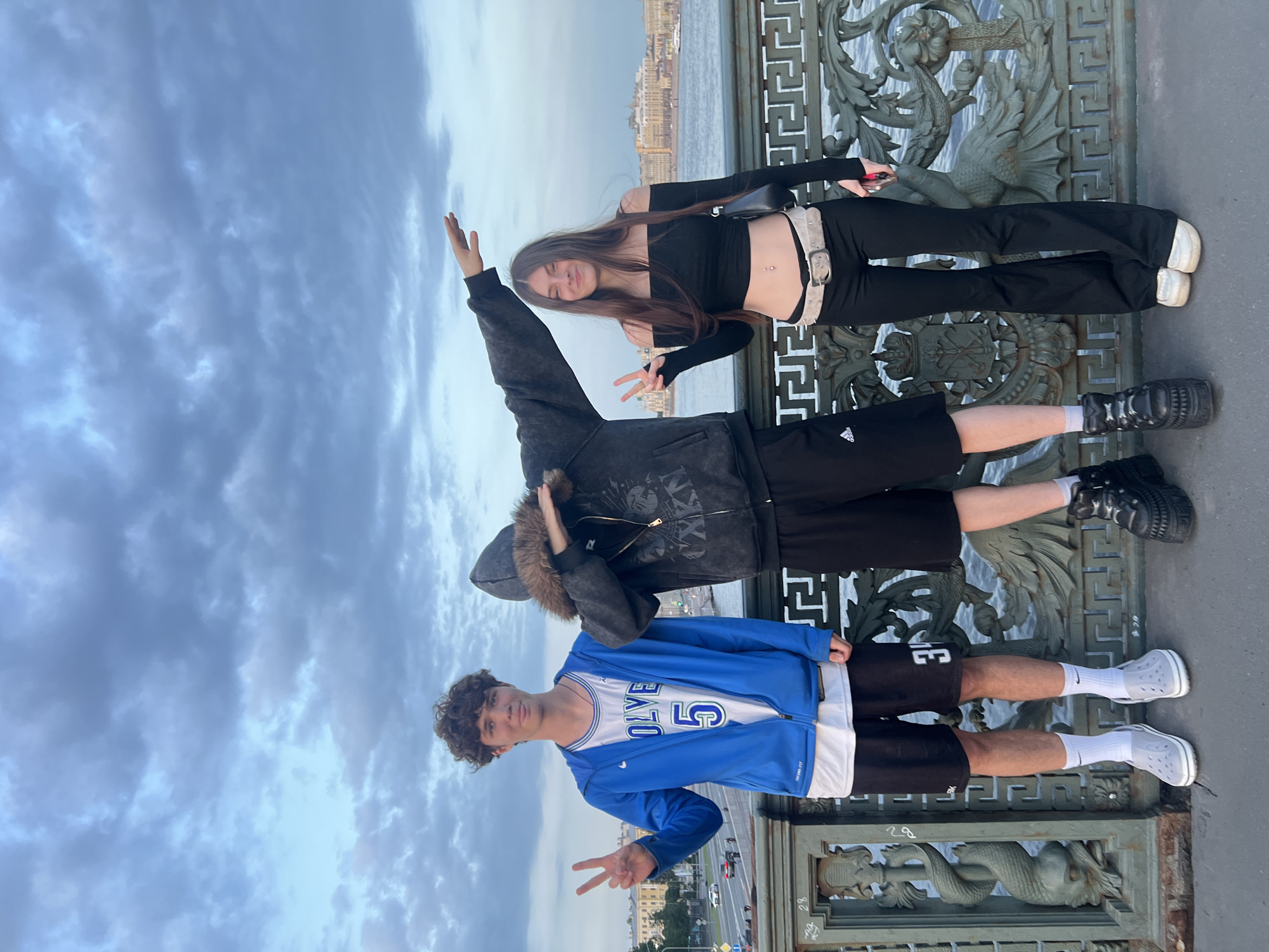 Young people gather on city bridge during evening hours