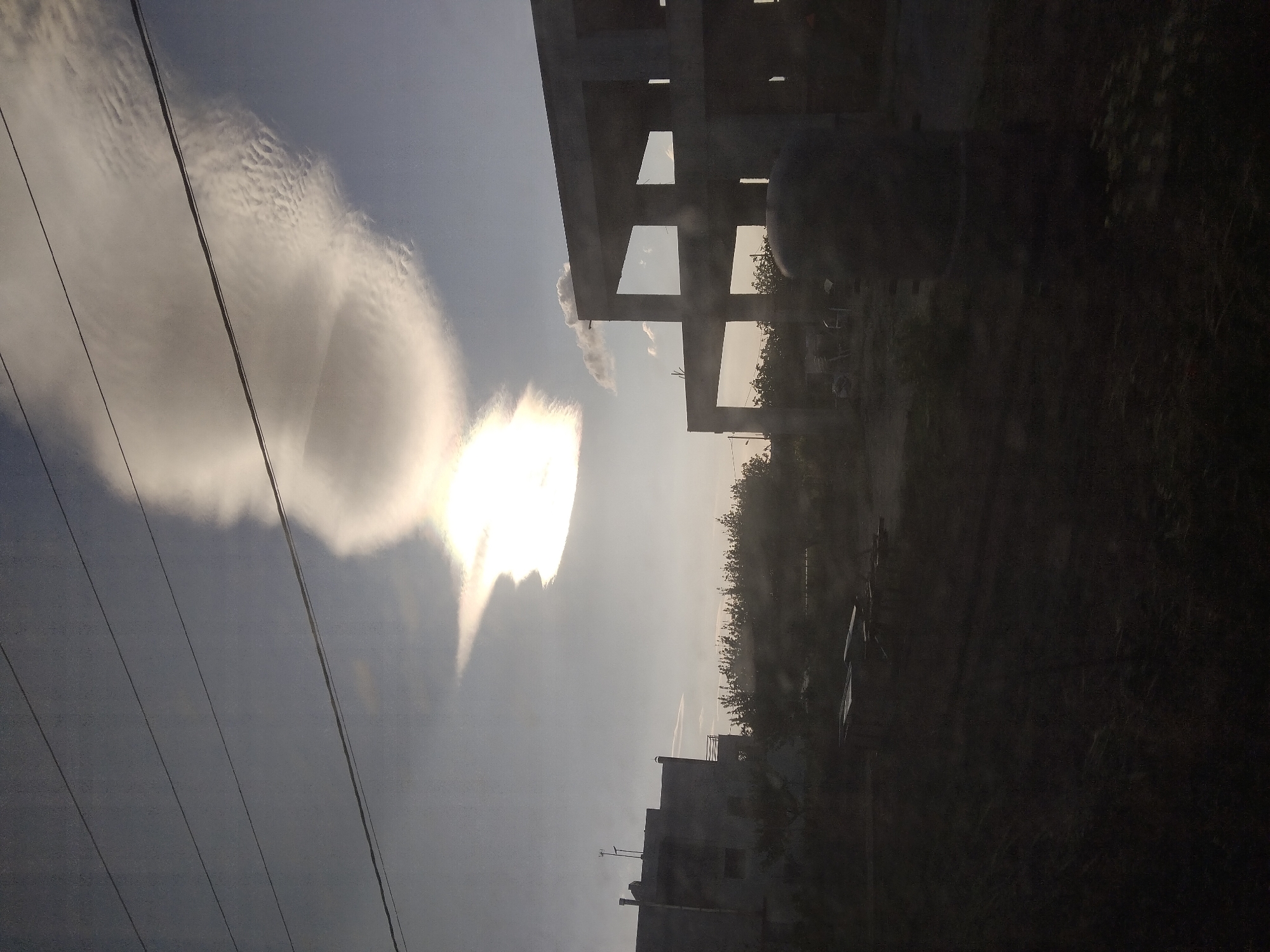 Vehicle passenger photographs dramatic clouds over Greek landscape