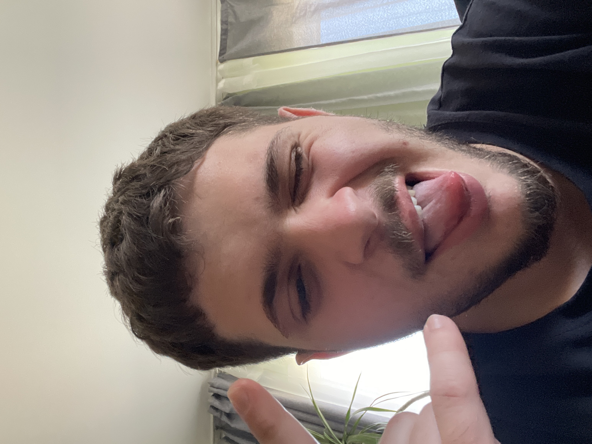 Man makes playful faces in Dragijevo, Bulgaria indoor setting