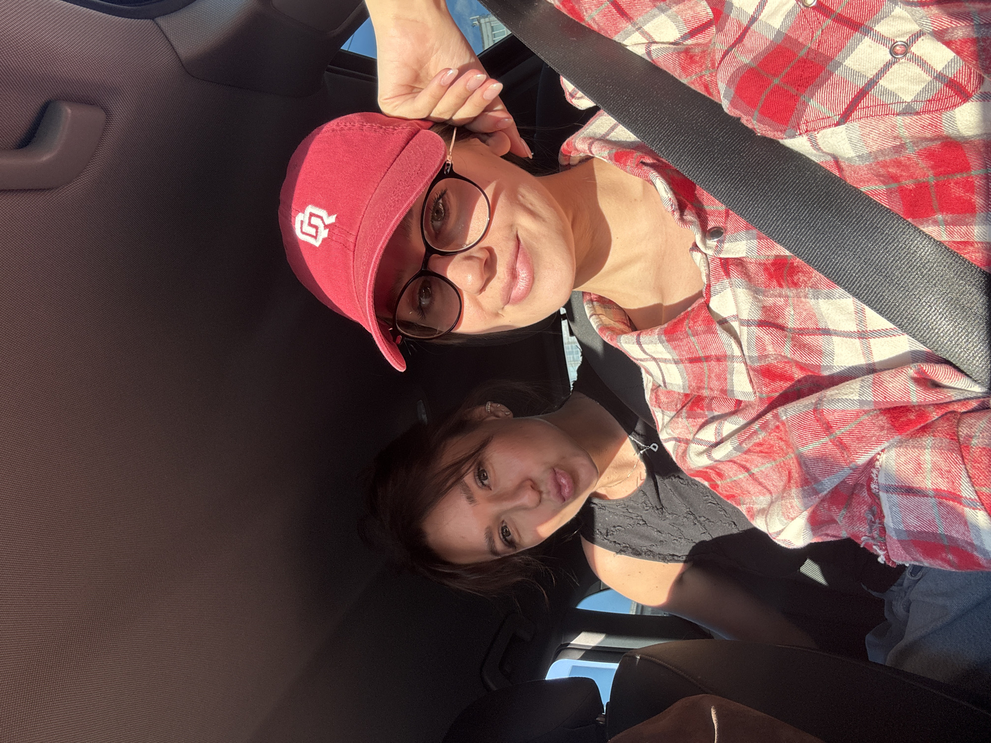 Three people photographed together in car in Krasnoyarsk