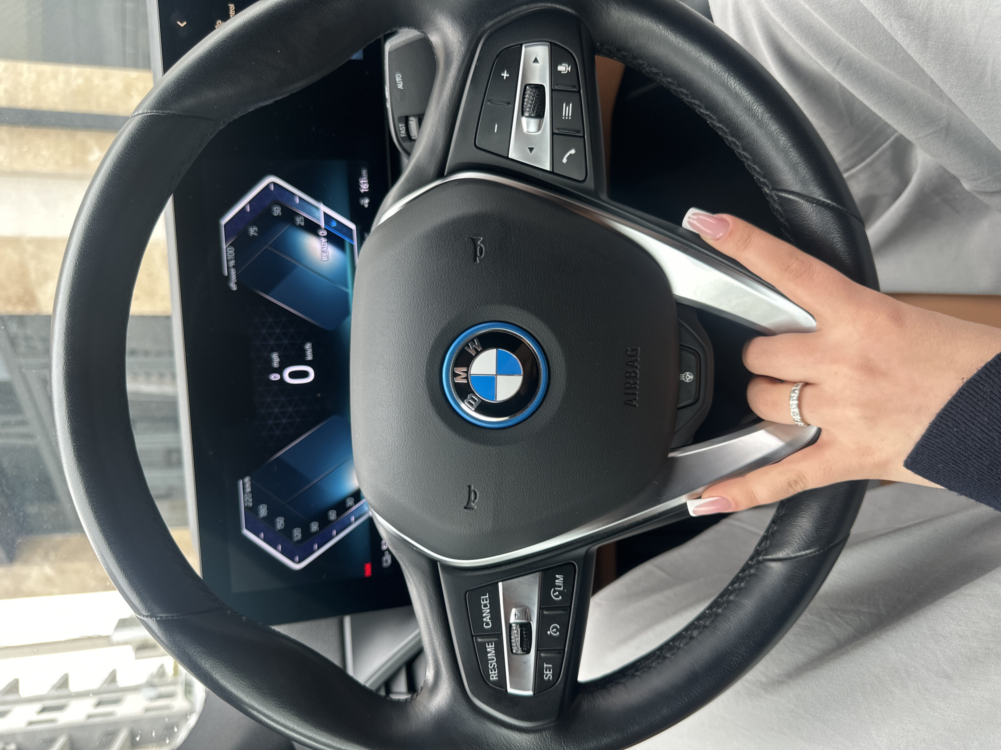Woman sits in BMW during rainy morning in Armenia