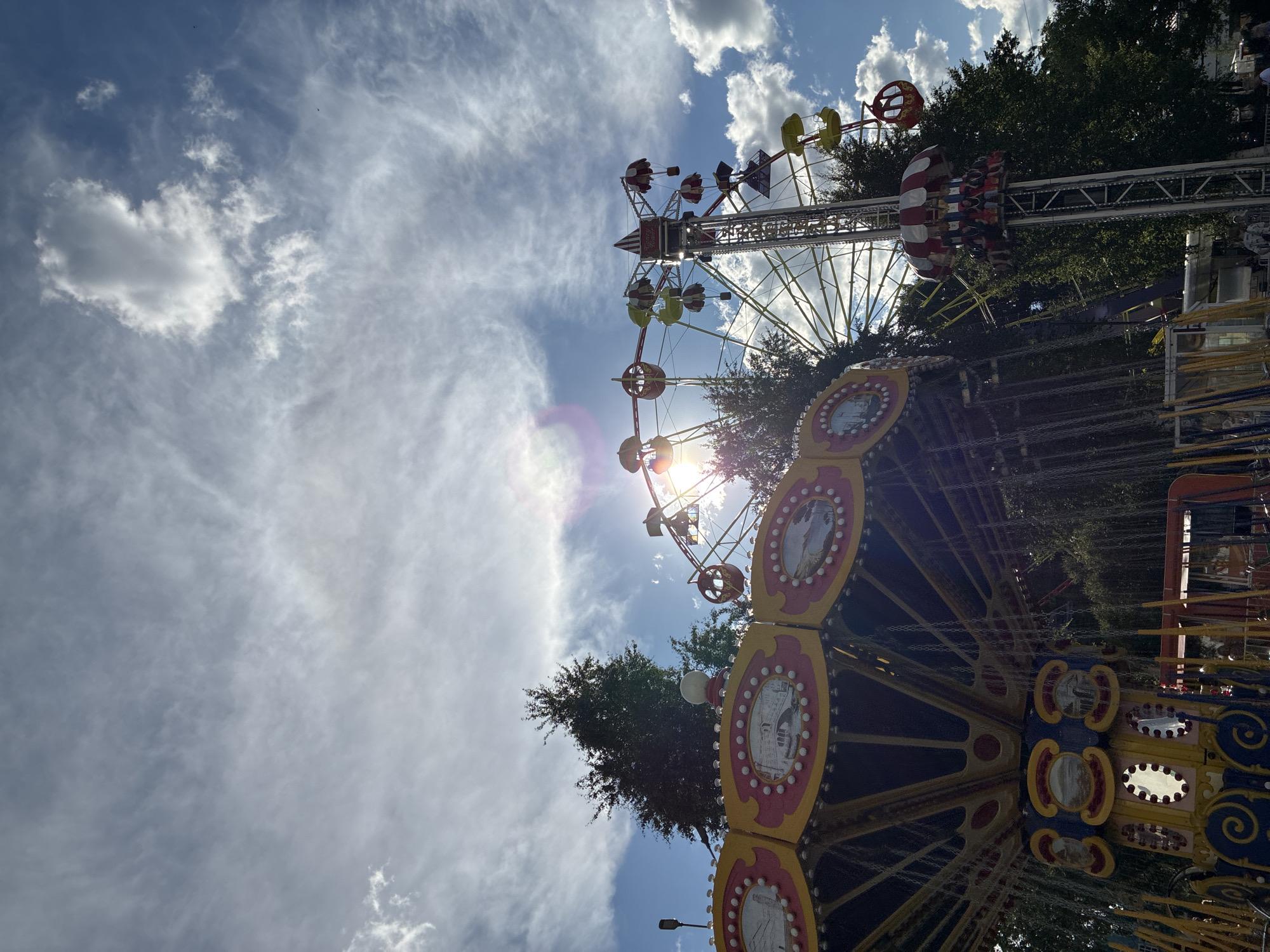Sunny afternoon at a Russian amusement park and waterfront promenade