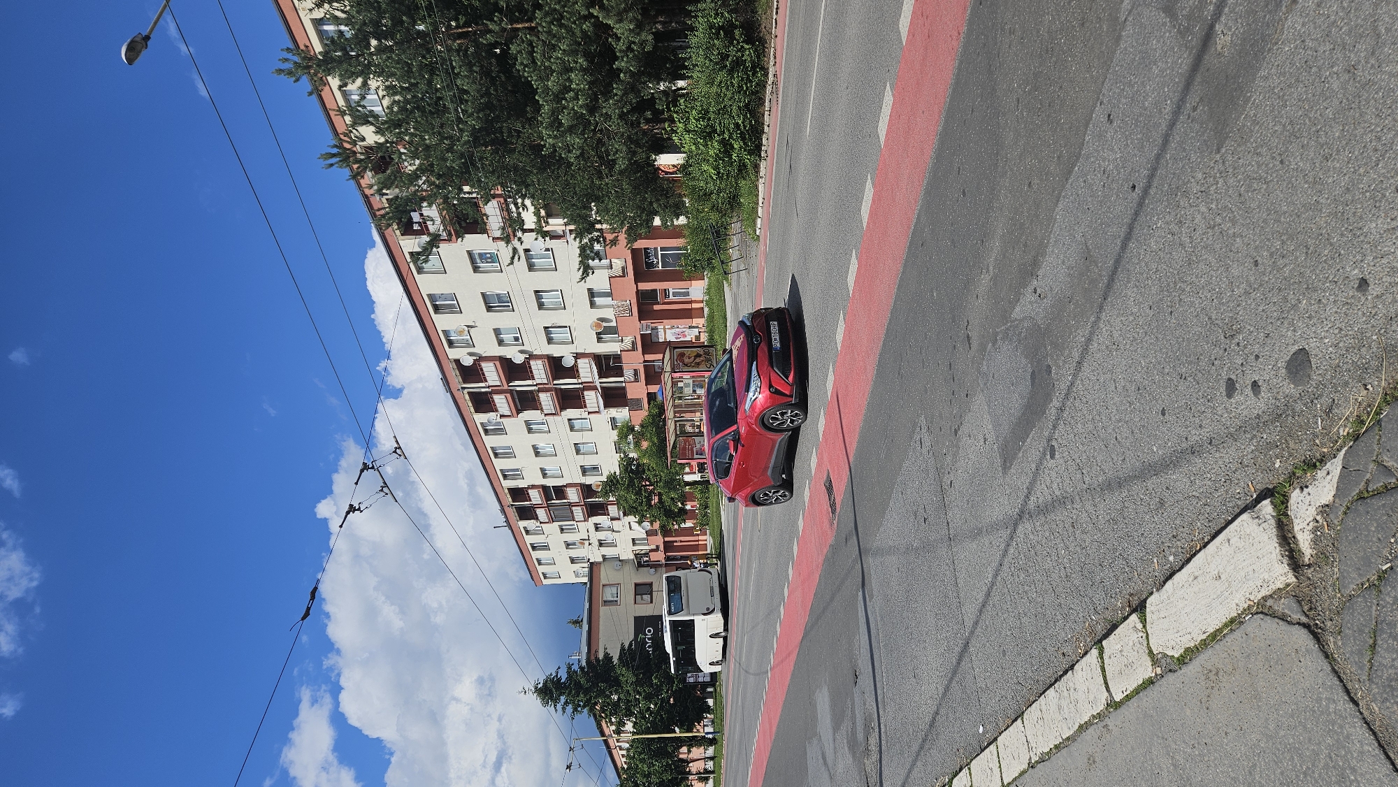 Red Toyota observed on Prešov street amid sunny afternoon