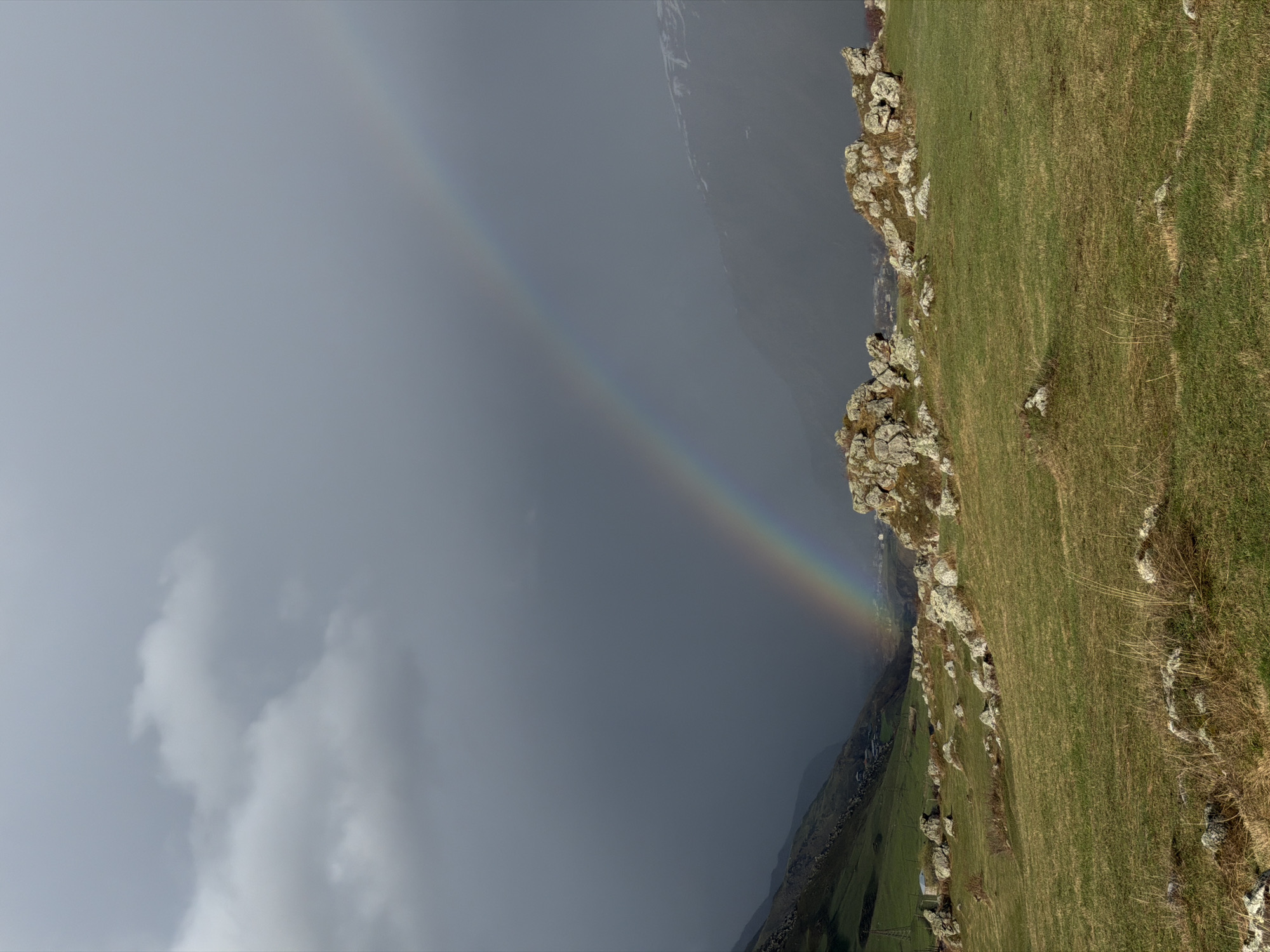 Rainbow appears over green hillside in Sioni, Georgia