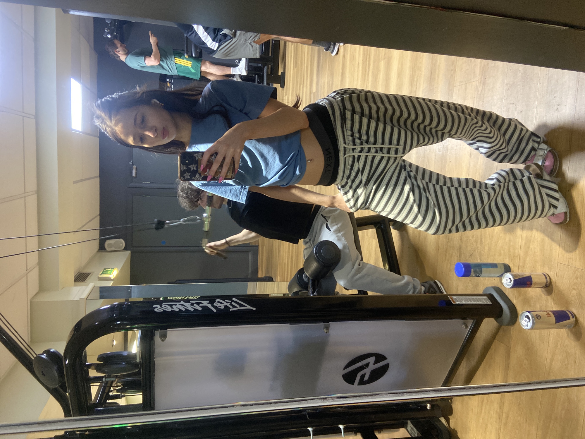Woman takes gym selfie in casual pajama outfit