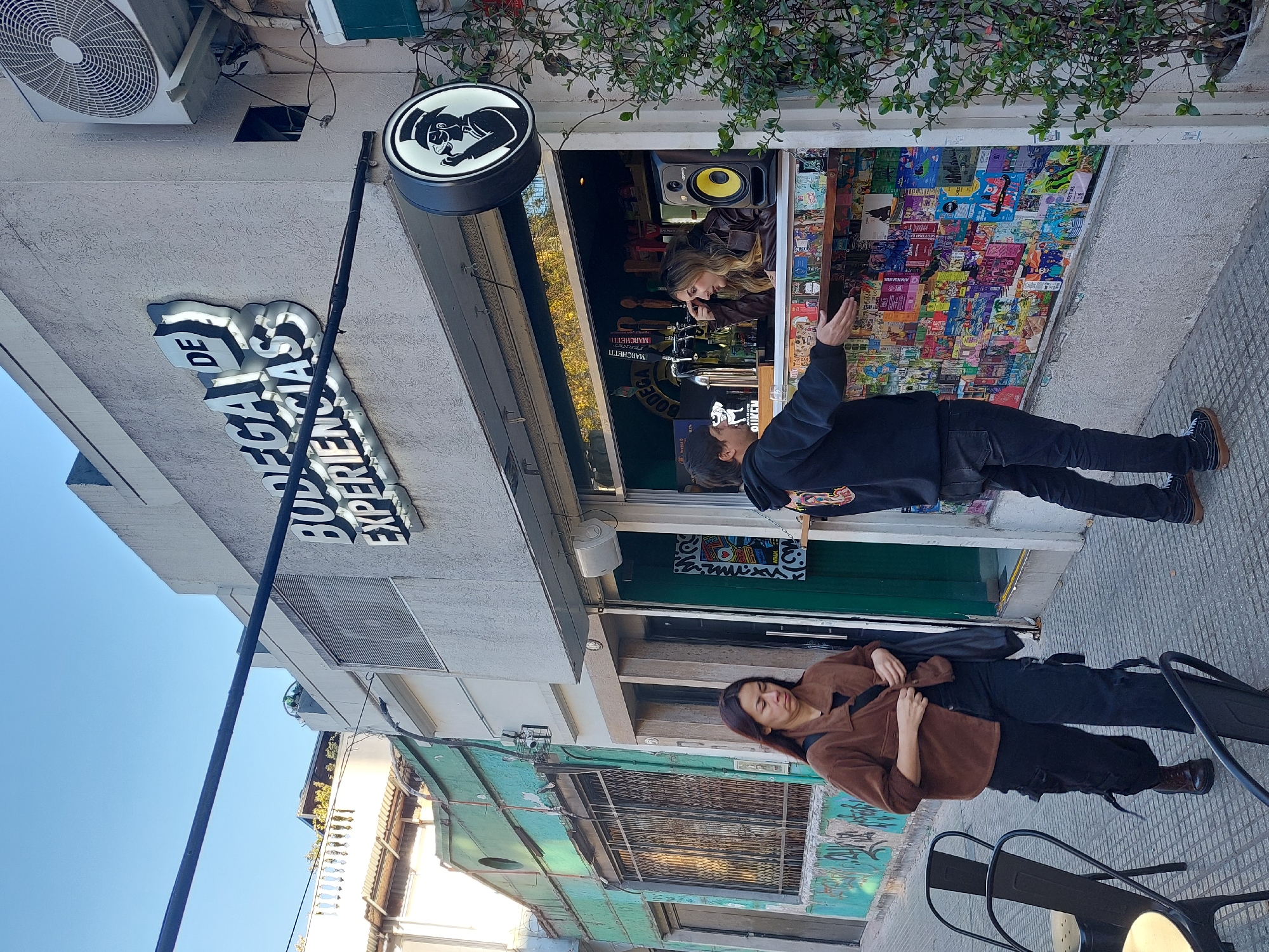 Evening street activity documented at Buenos Aires storefronts