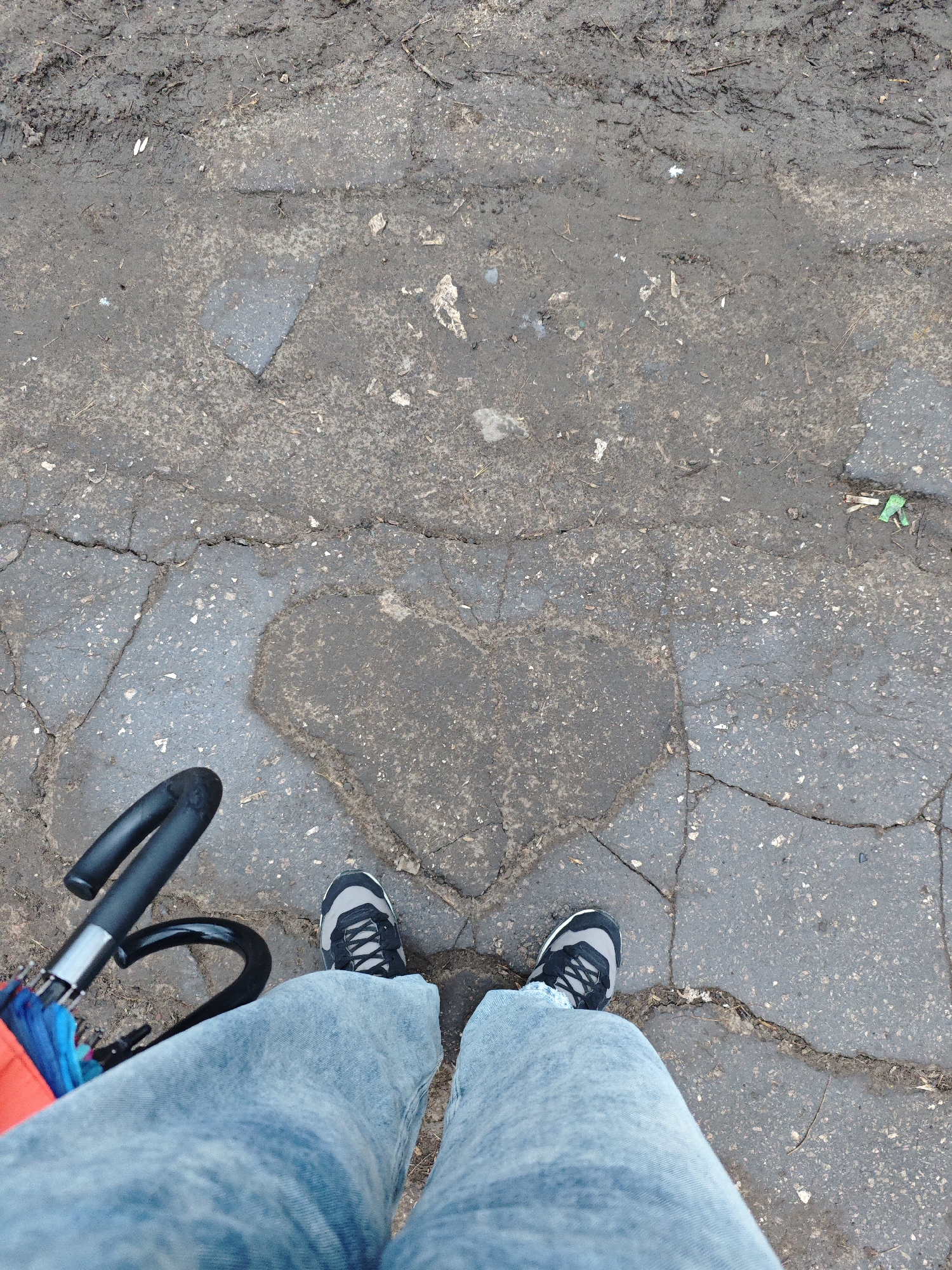 Person stands on heart-shaped pavement patch in Samara