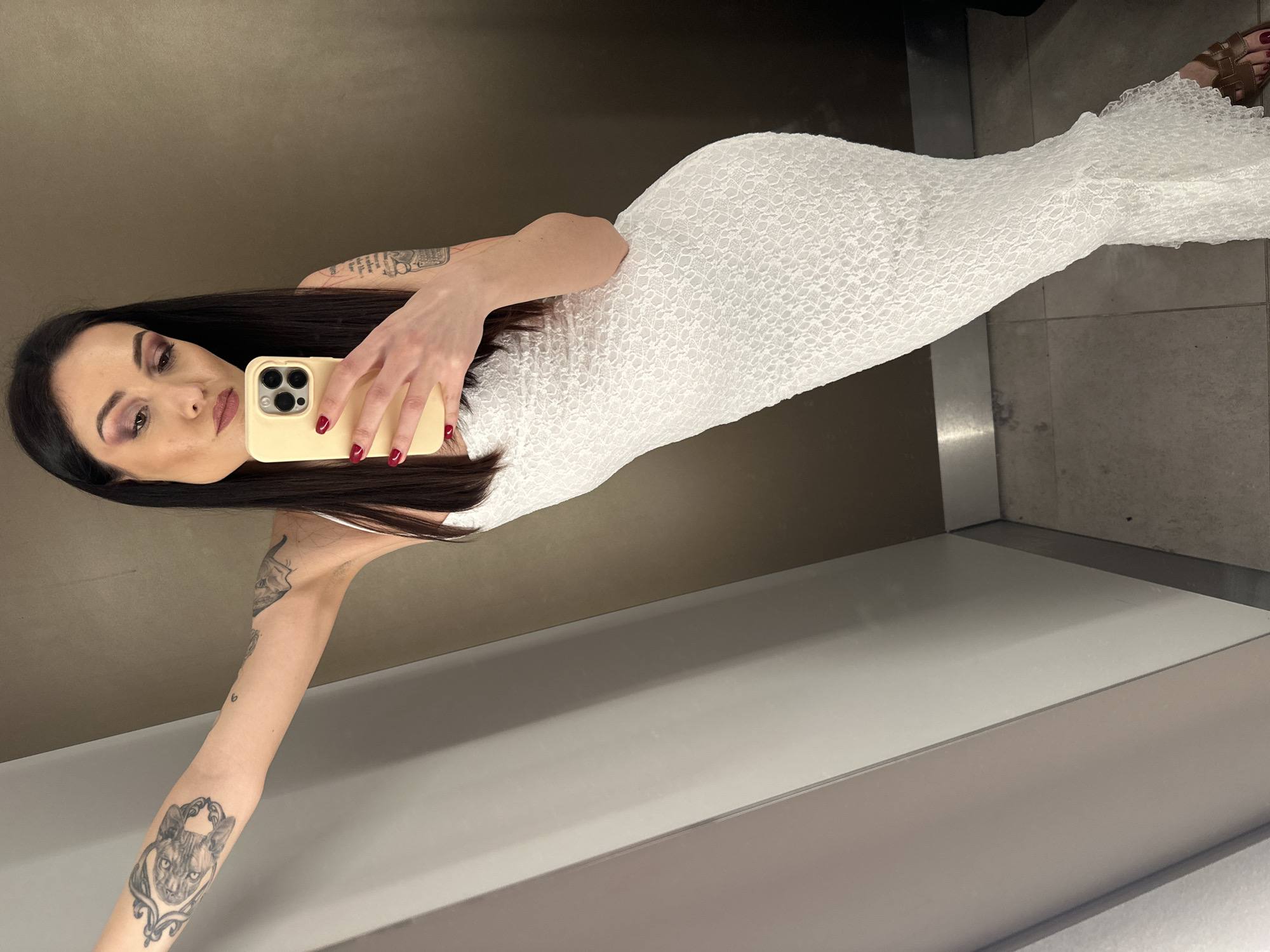 Woman takes selfie in dressing room mirror