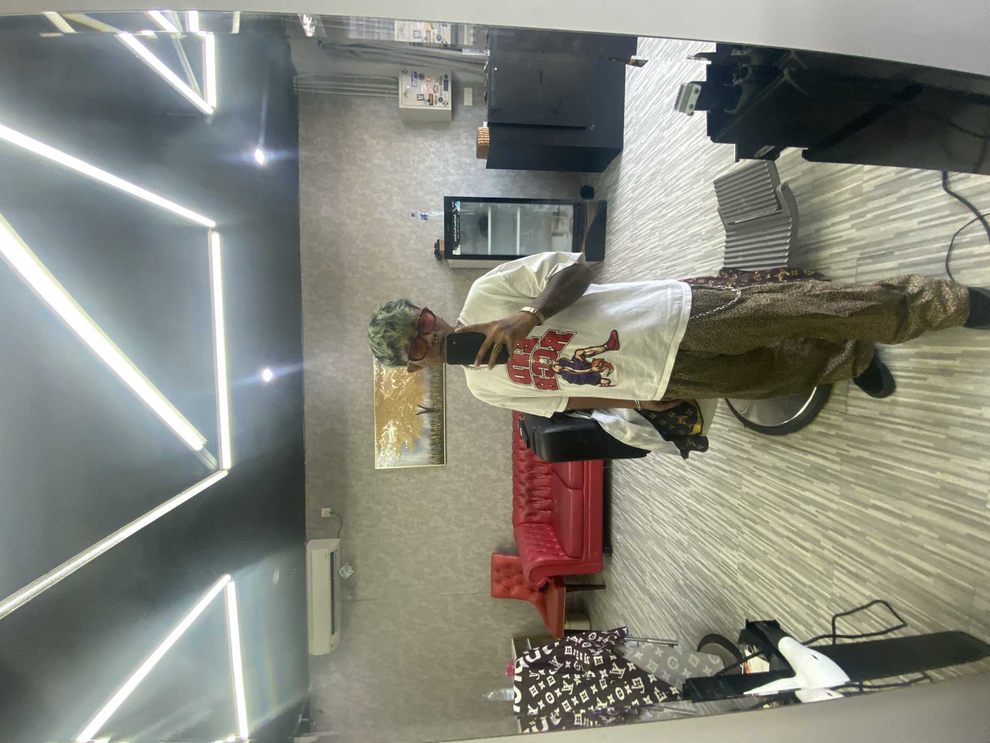 Green-haired person takes salon selfie in Kuta, Indonesia