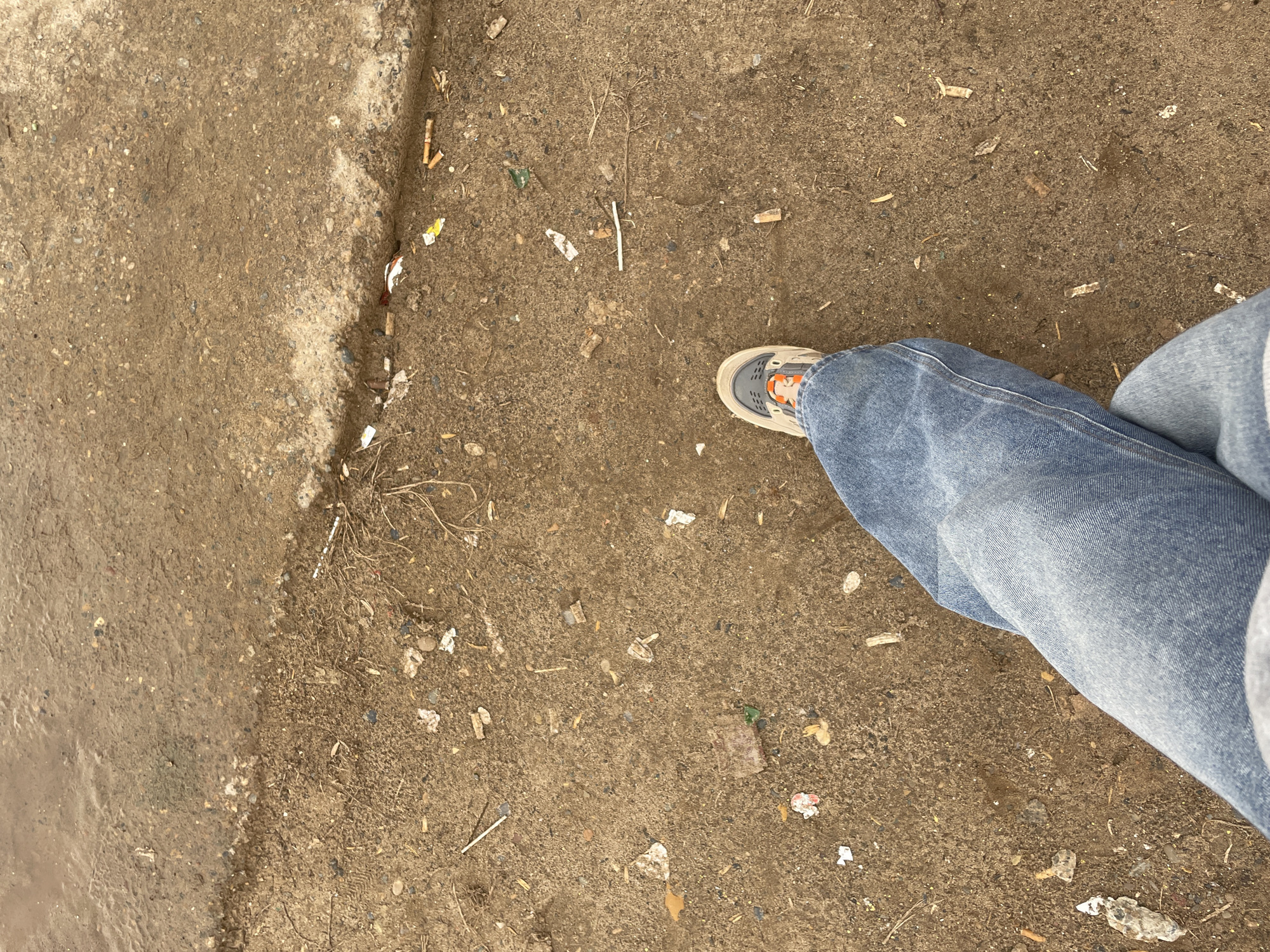 Woman observed on littered sidewalk in Ольховка, Russia
