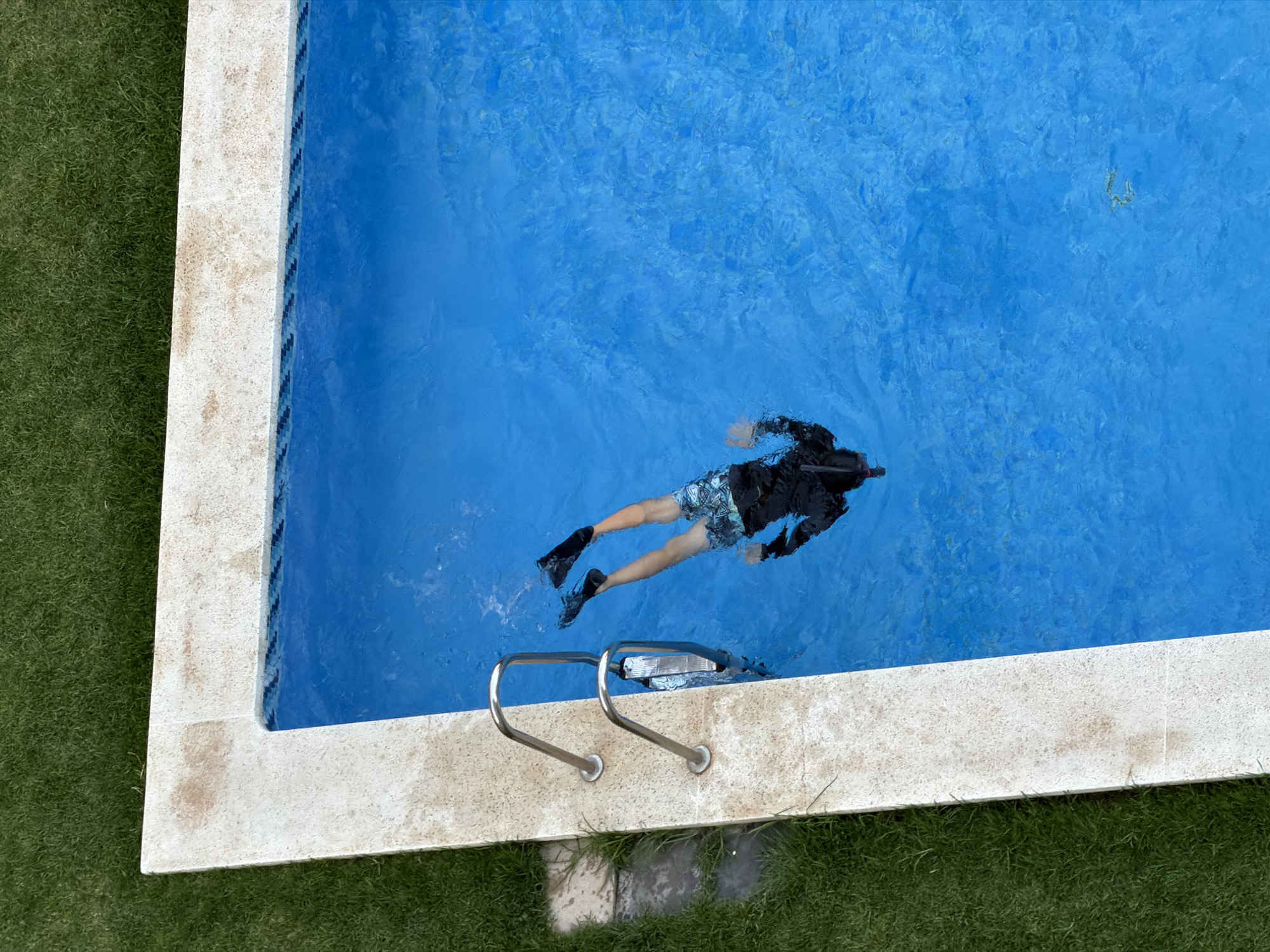Summer evening at a Valencia residential complex: pools, cava, and courtyard hangs