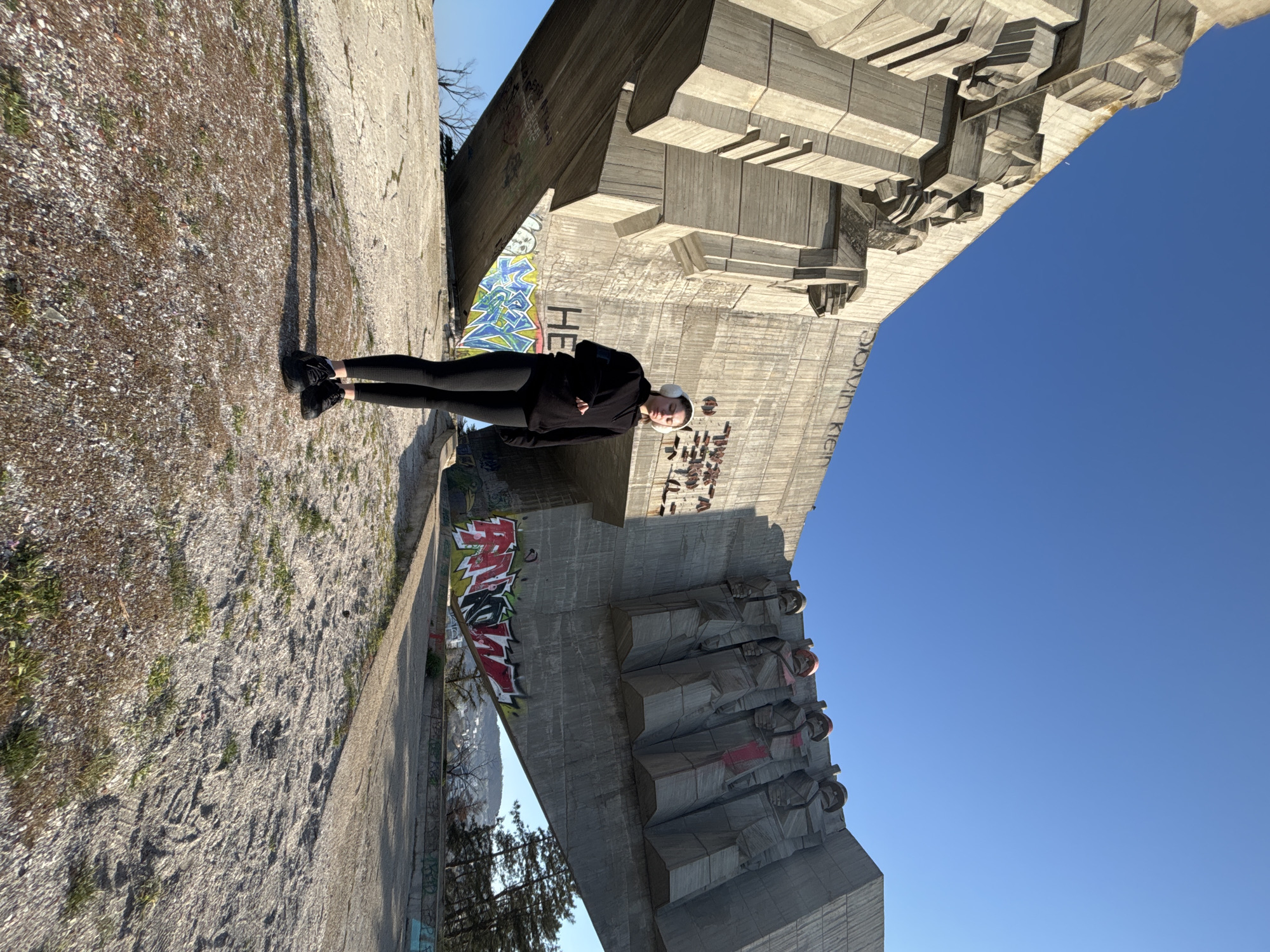 Person performs morning yoga on urban concrete monument