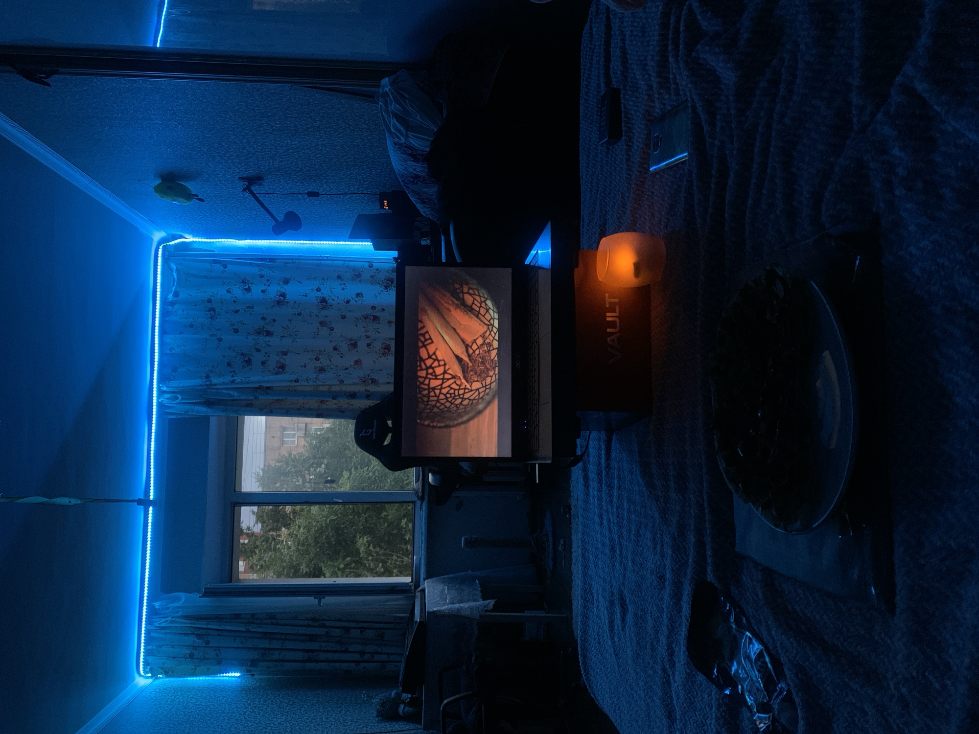 Blue LED-lit bedroom glowing at night in Klin, Russia