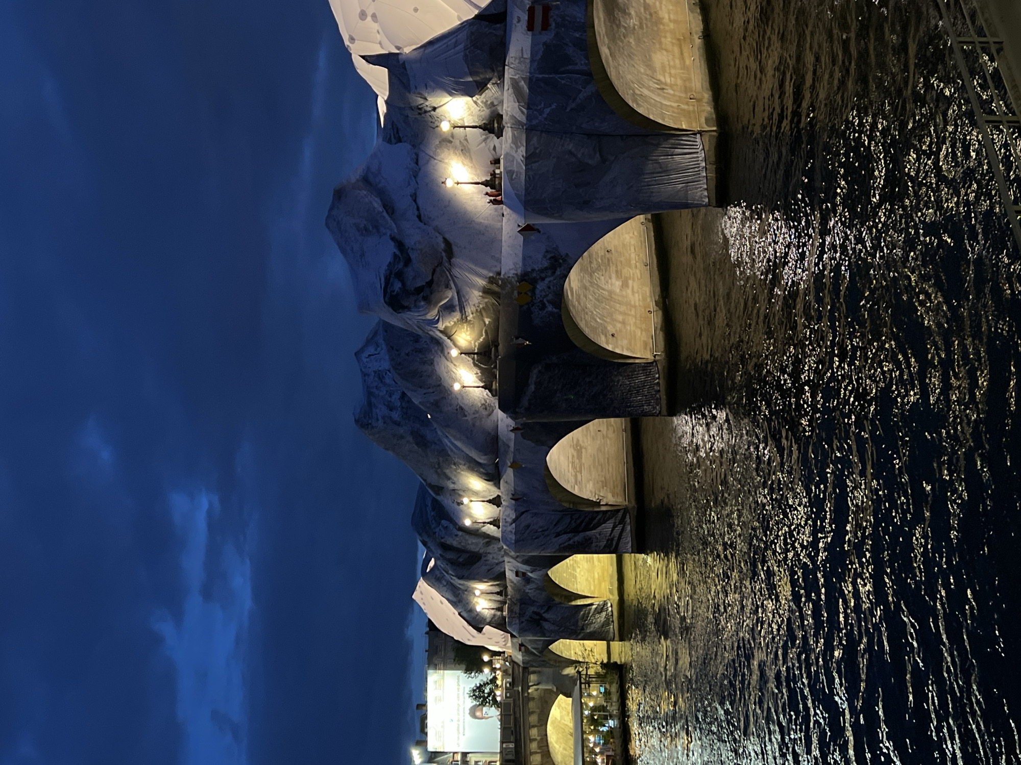White fabric art installation transforms Paris bridge into alpine landscape