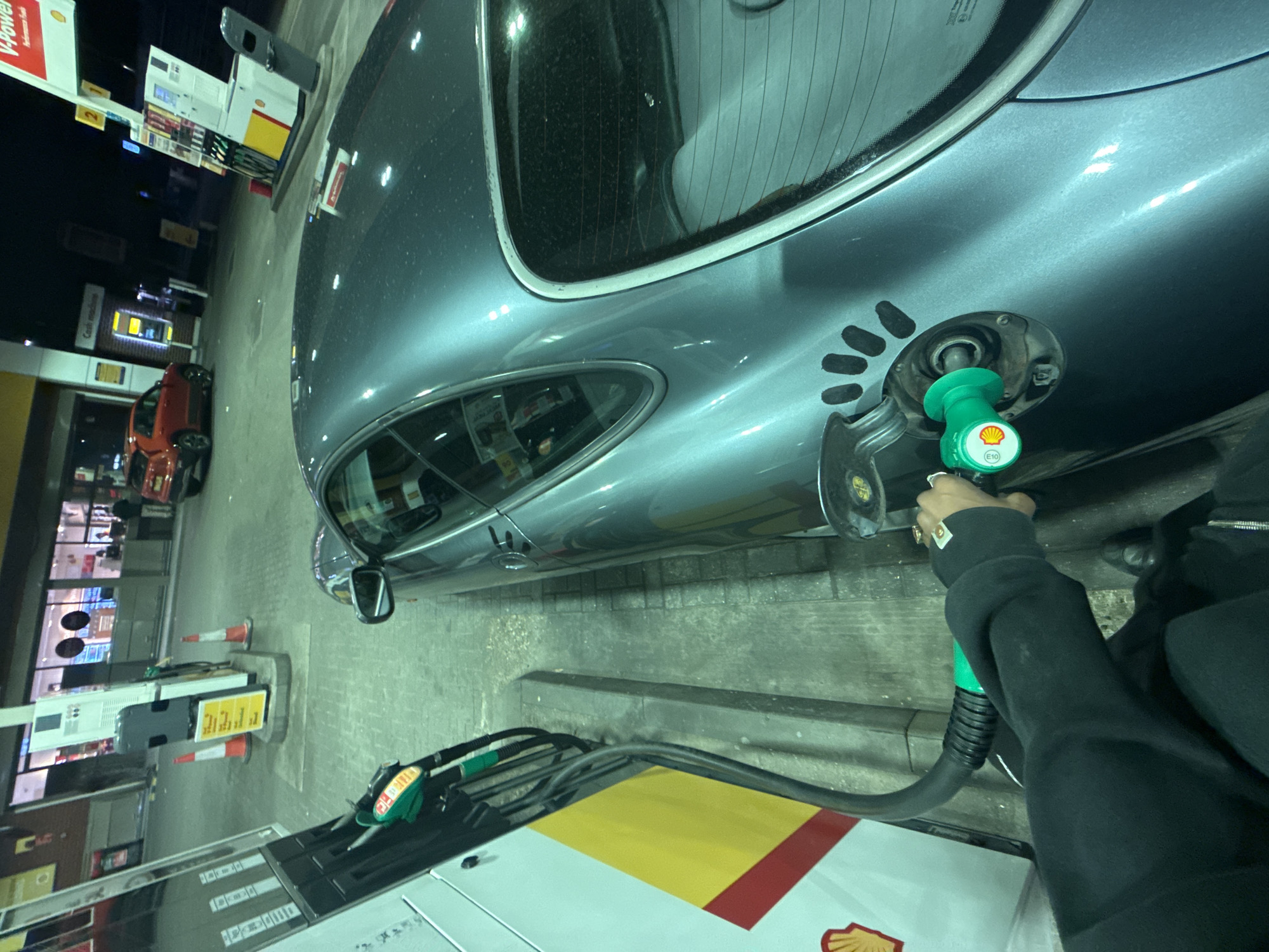 Grey car refueled at London Shell station Tuesday night