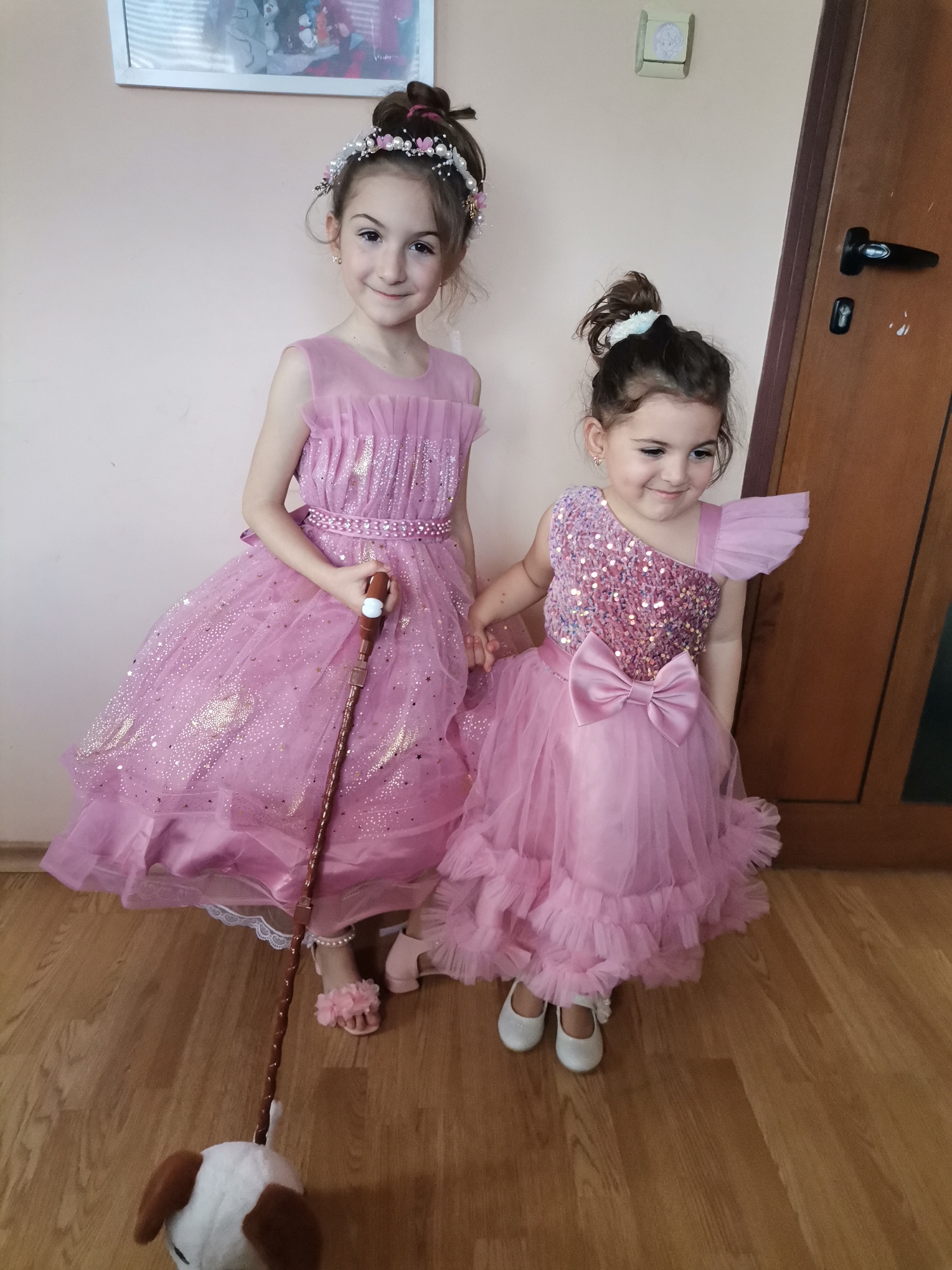Girls in pink dresses pose for photos in Bulgaria home