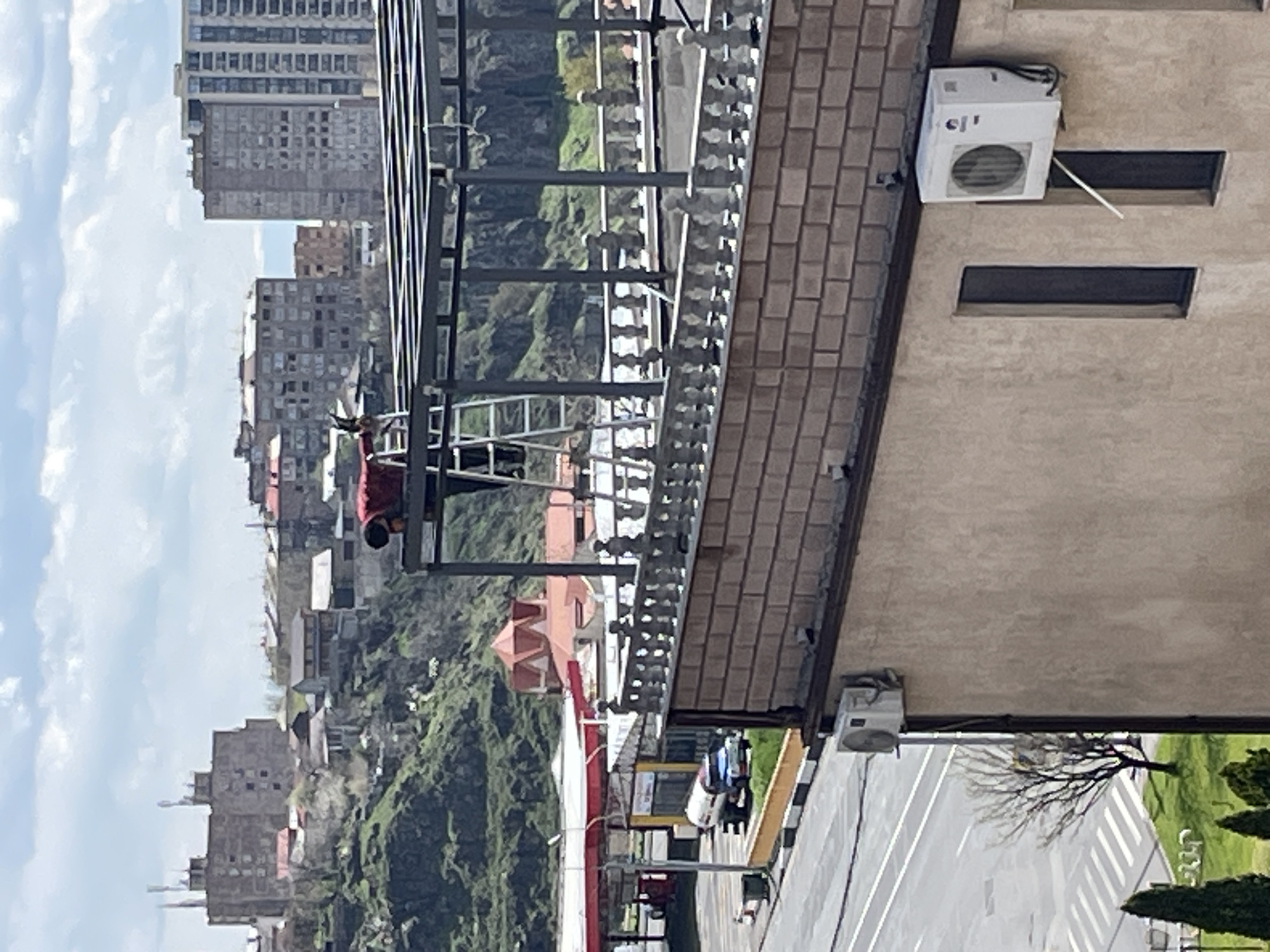 Worker performs rooftop maintenance on Yerevan building Tuesday morning