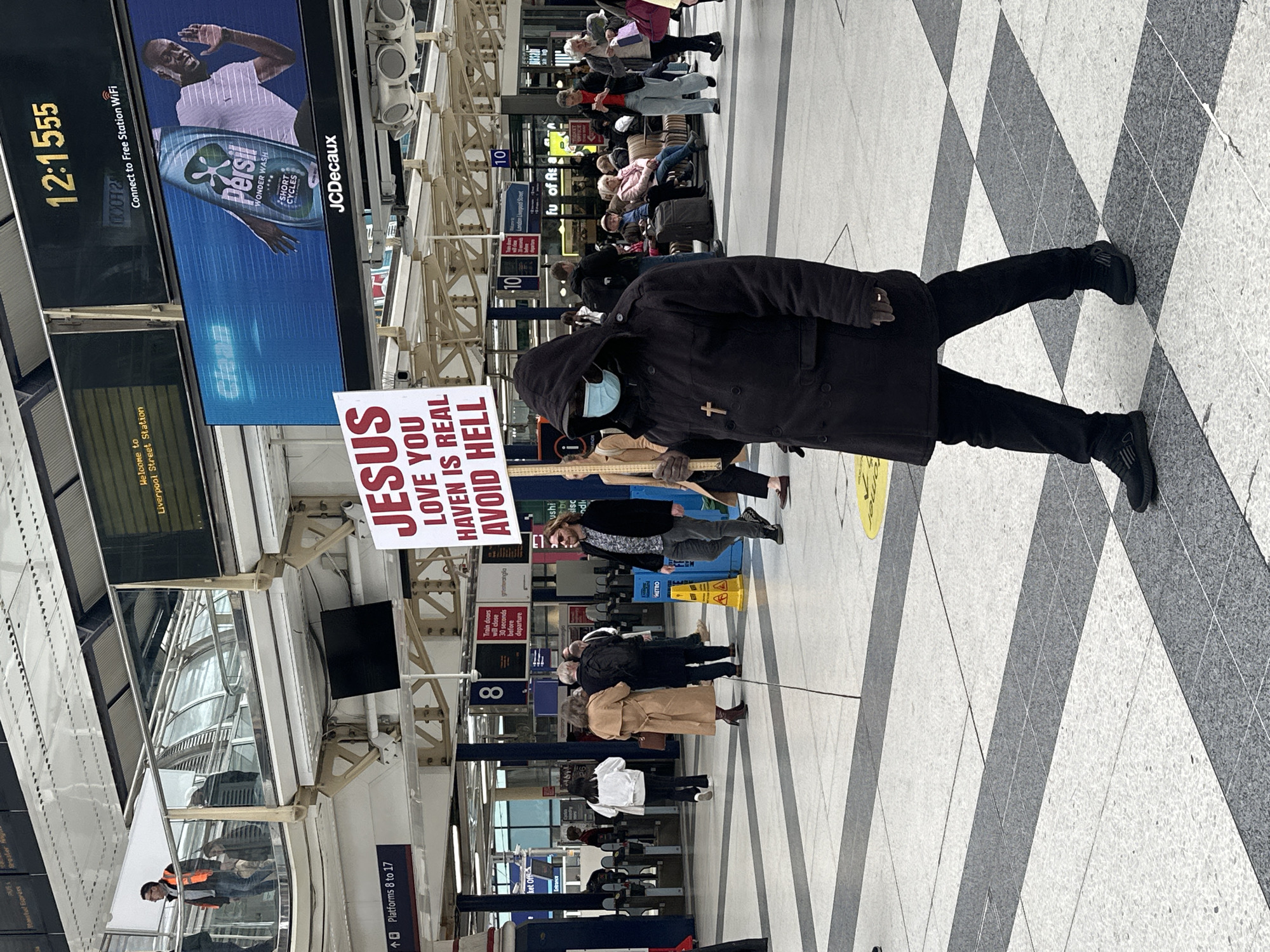 Religious preacher displays sign at Liverpool Street Station