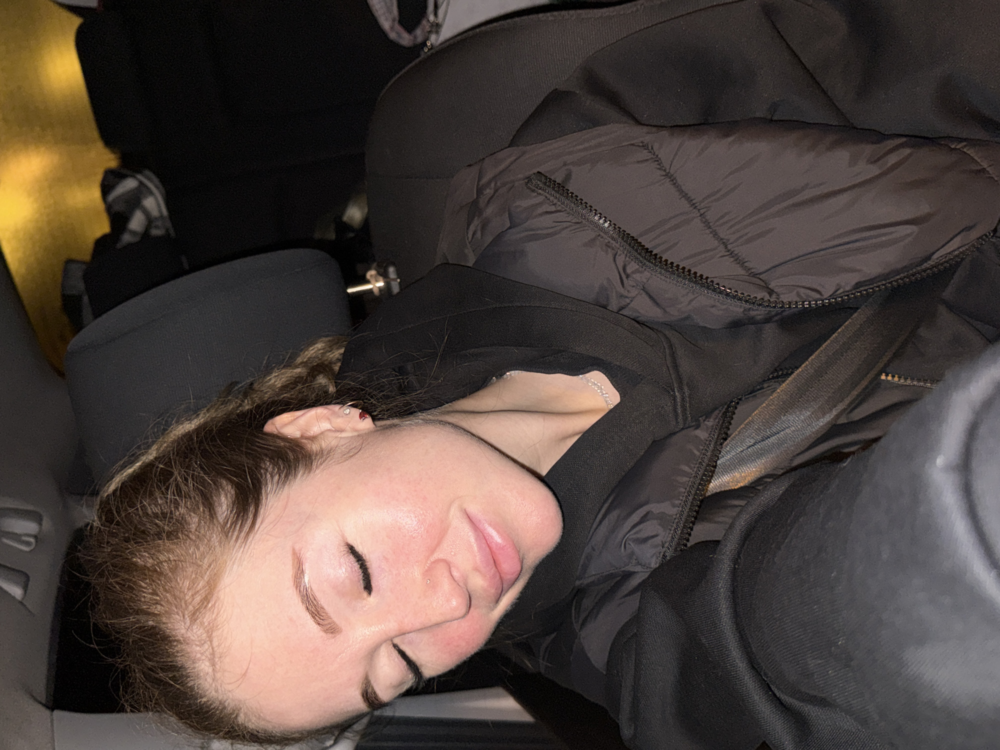 Woman sleeps in car backseat in Kryukovo, Russia