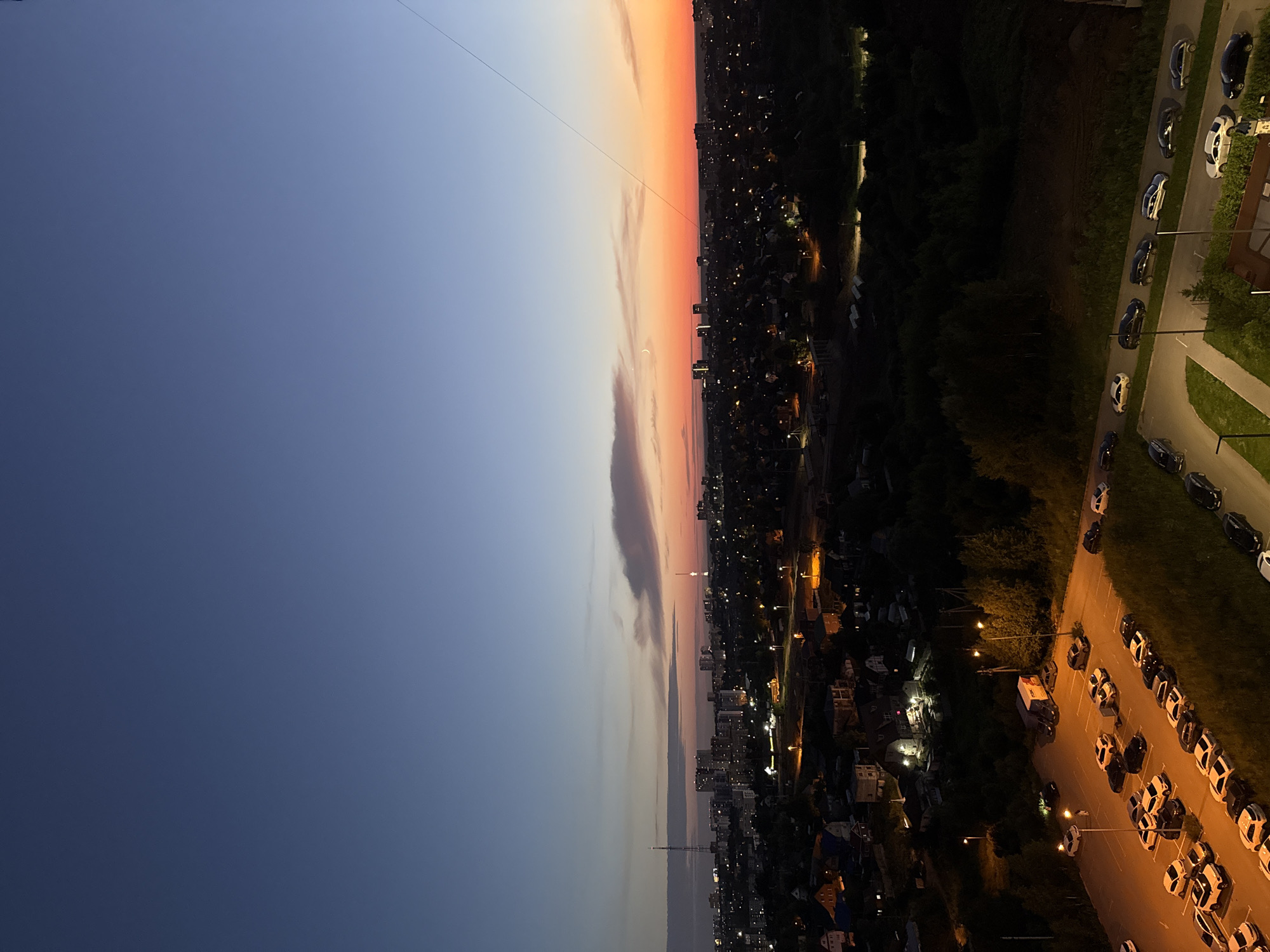 Balcony evening in Perm: corgi, sunset, and city lights