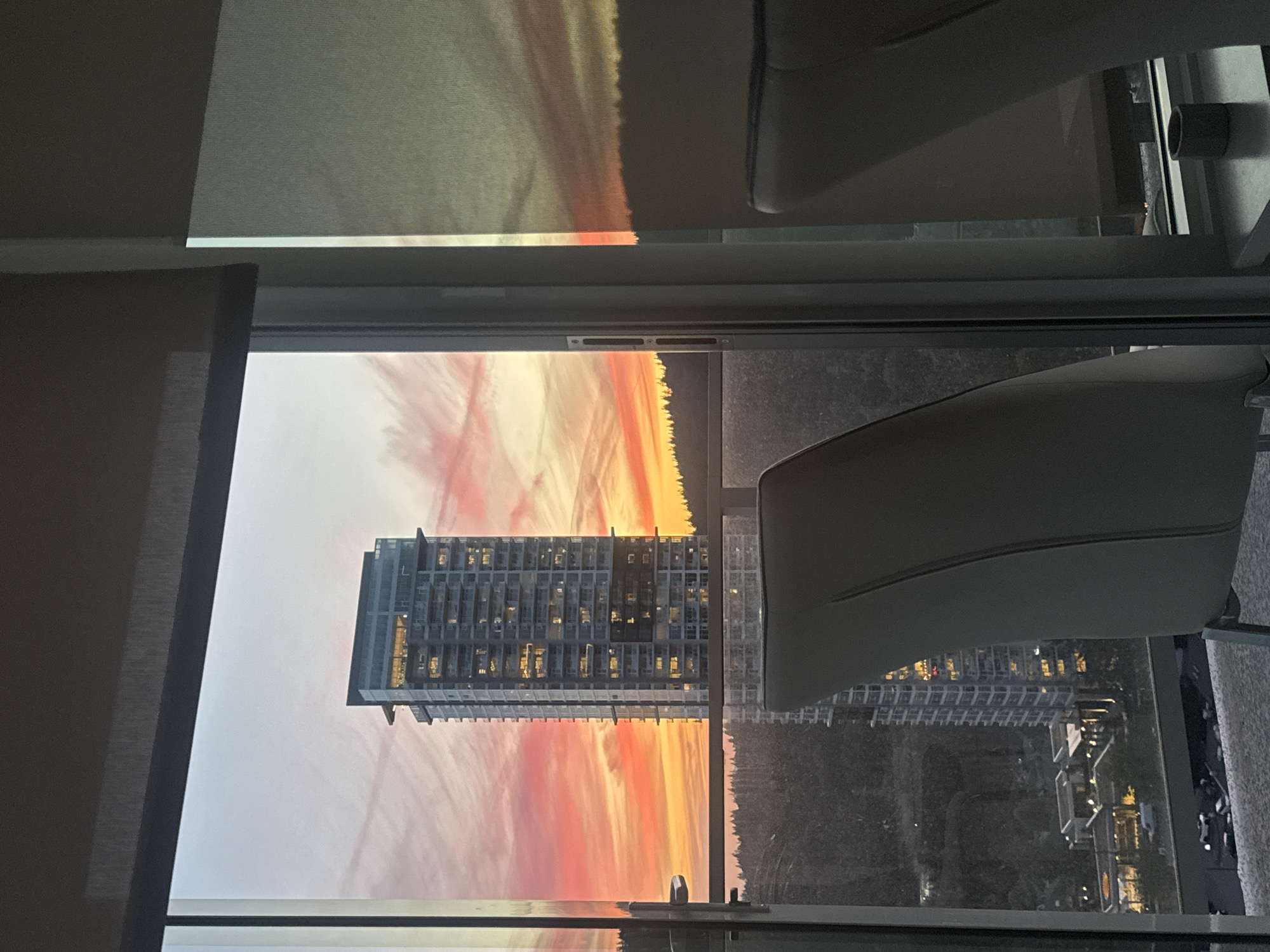 Sunset over Coquitlam framed through a high-rise window