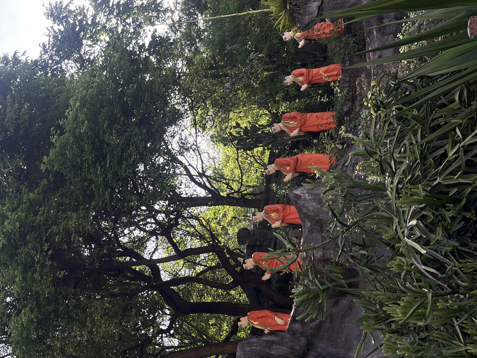 Monk statues in orange robes observed on Dambulla rock formation