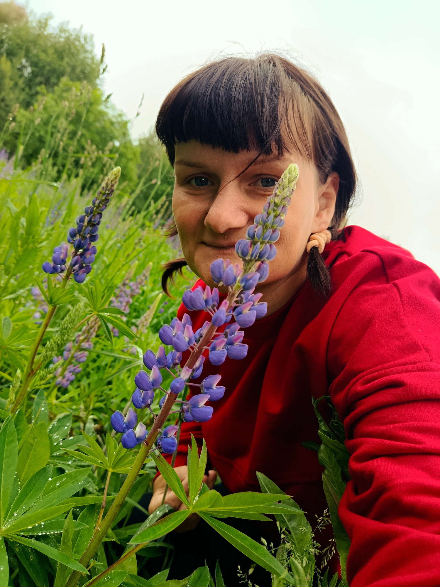 Woman photographed with lupine flowers in rural Russia