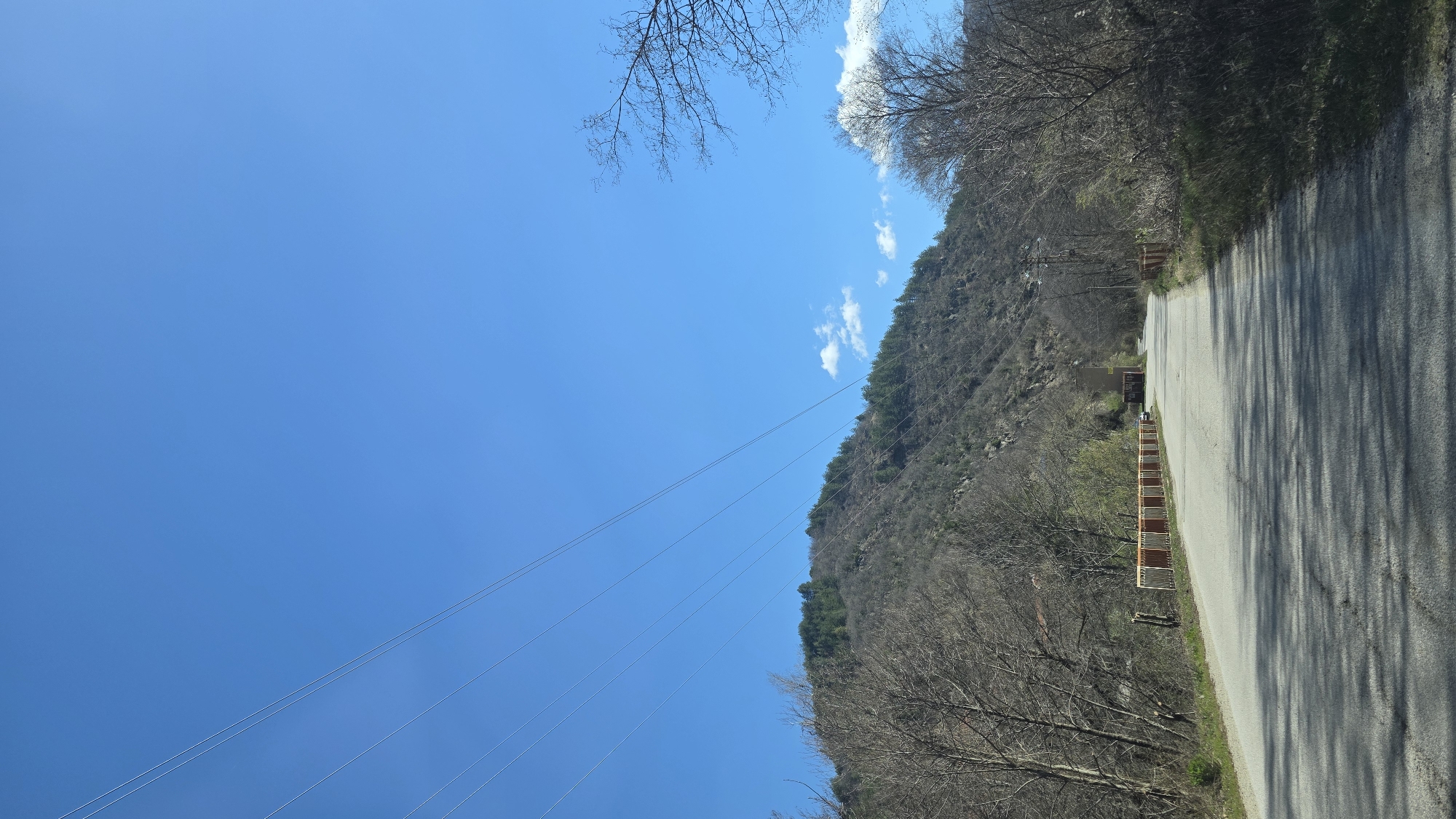 Morning documentation of rural roadway and waterfall in Bistritsa