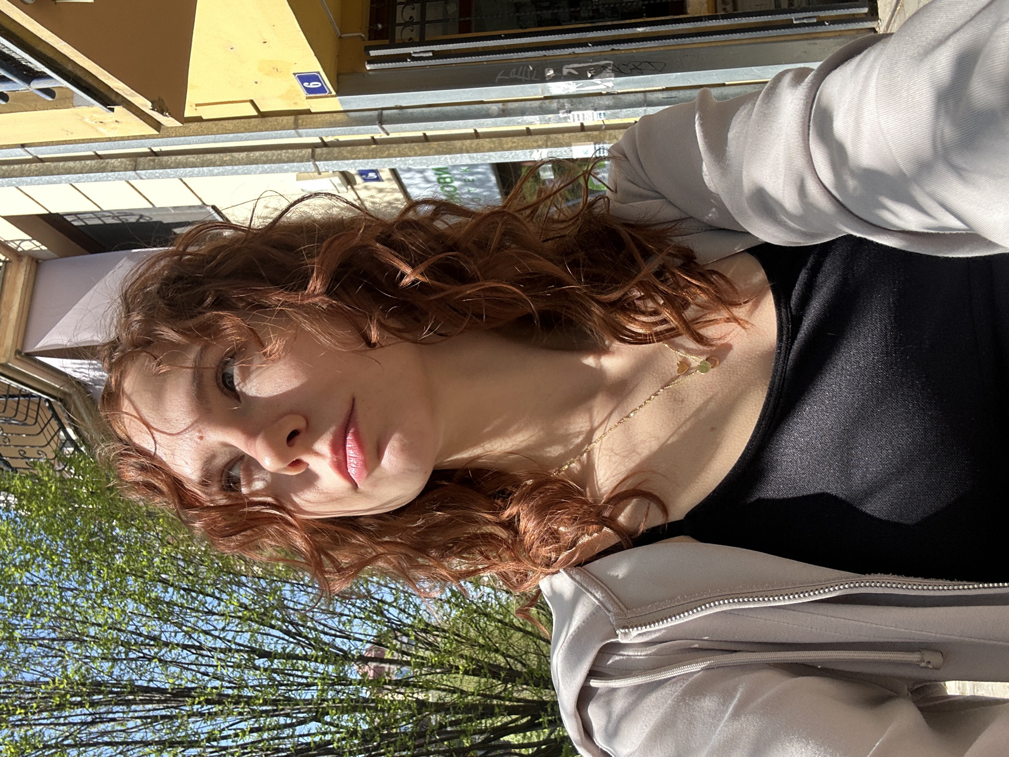 Woman enjoys outdoor pastry break in sunny Novi Sad
