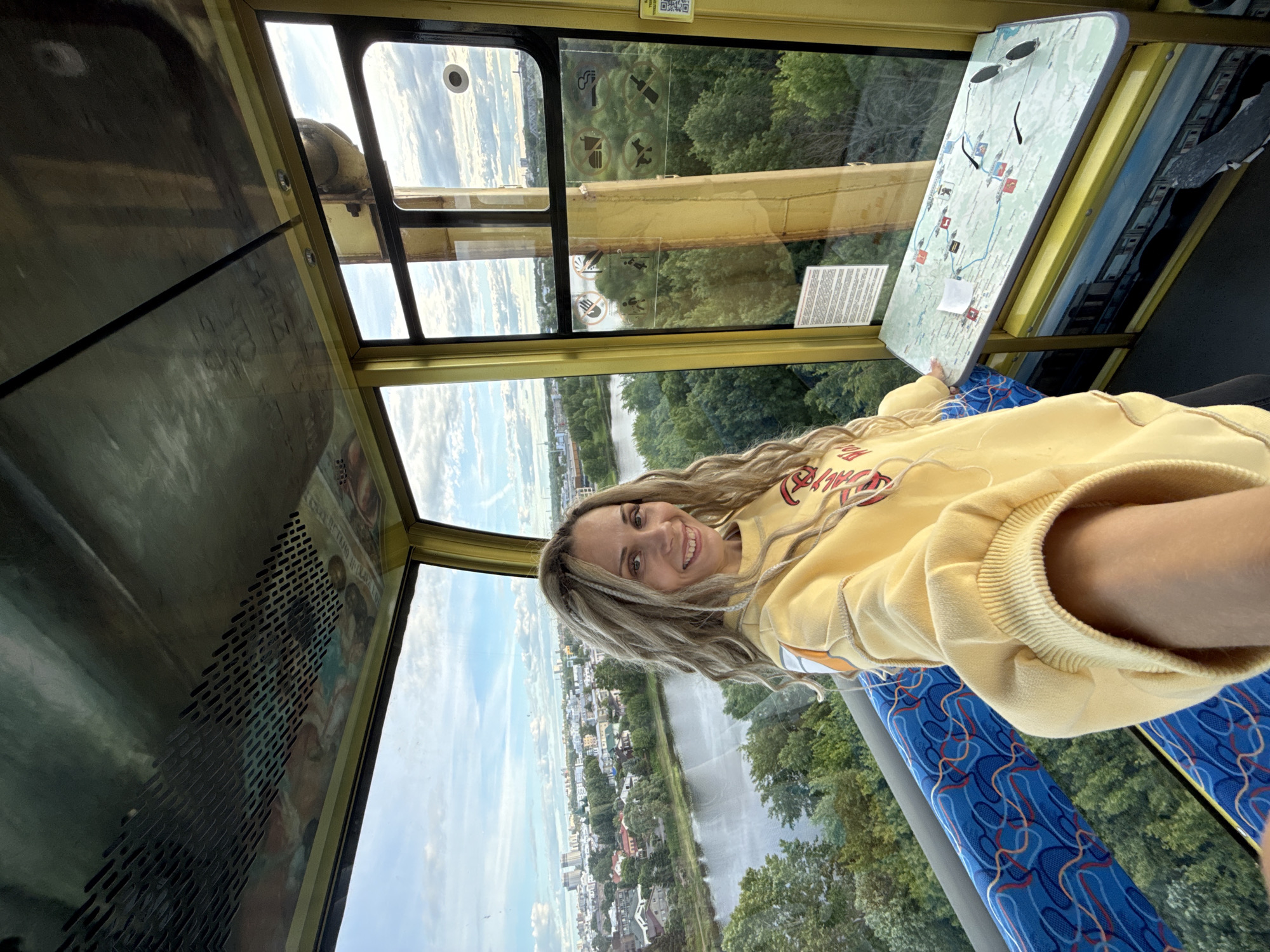 Woman rides cable car with city views in Шебунино