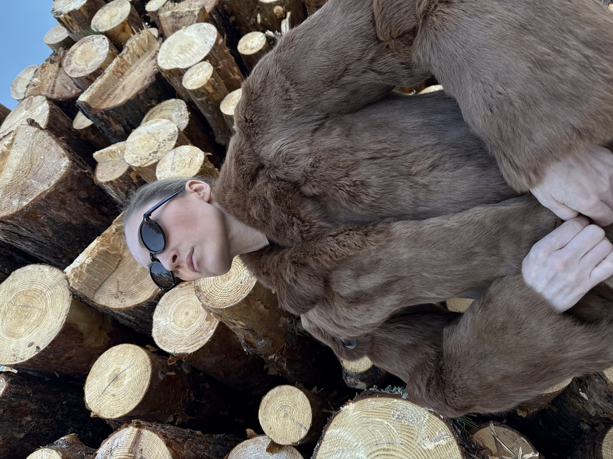 Woman poses for outdoor photoshoot at Russian lumber yard