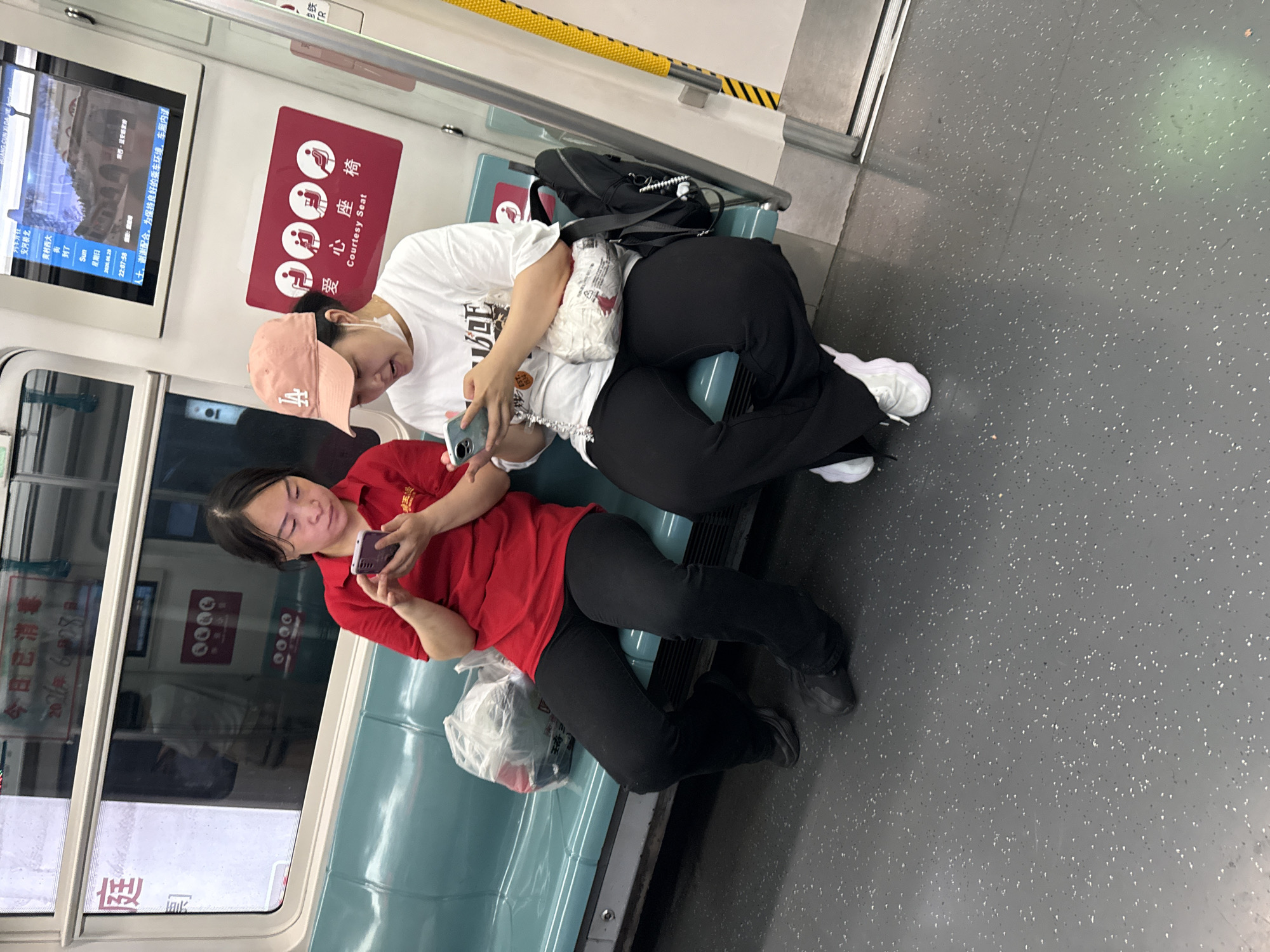 Passengers on phones aboard a Daxing District subway