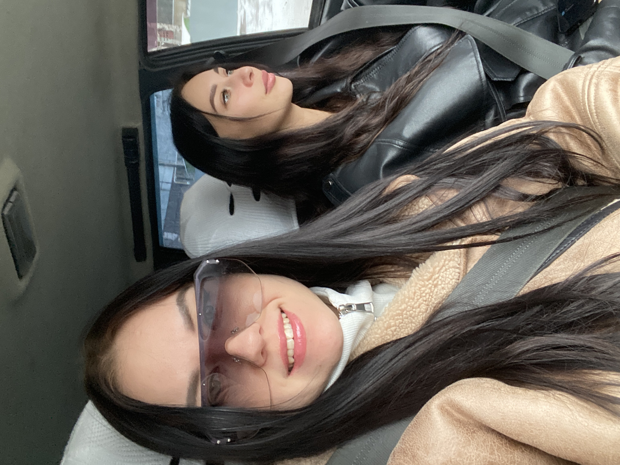 Two women relax in car backseat in Chaikovsky