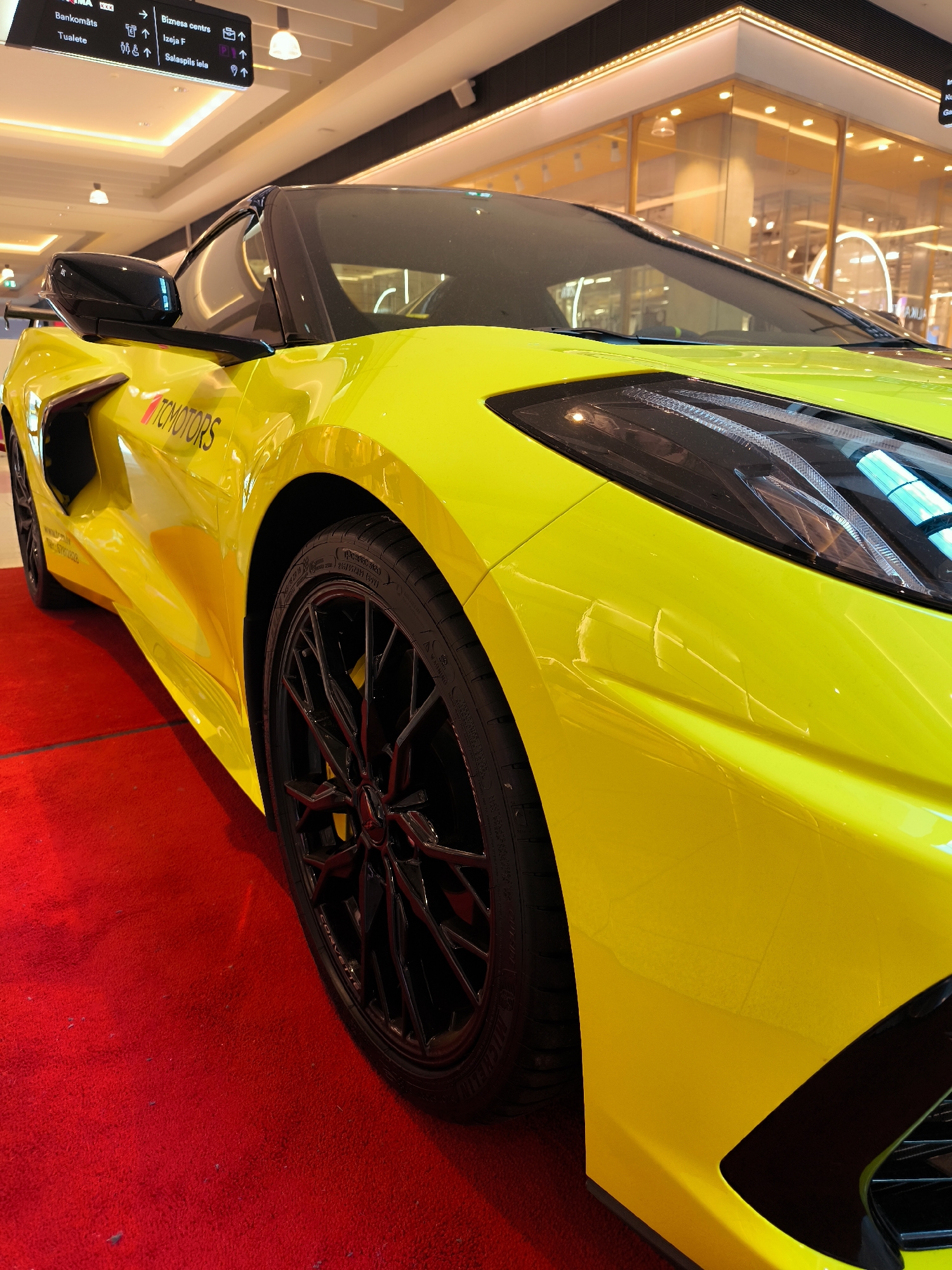 Corvette C8 and luxury branding at a Riga indoor event