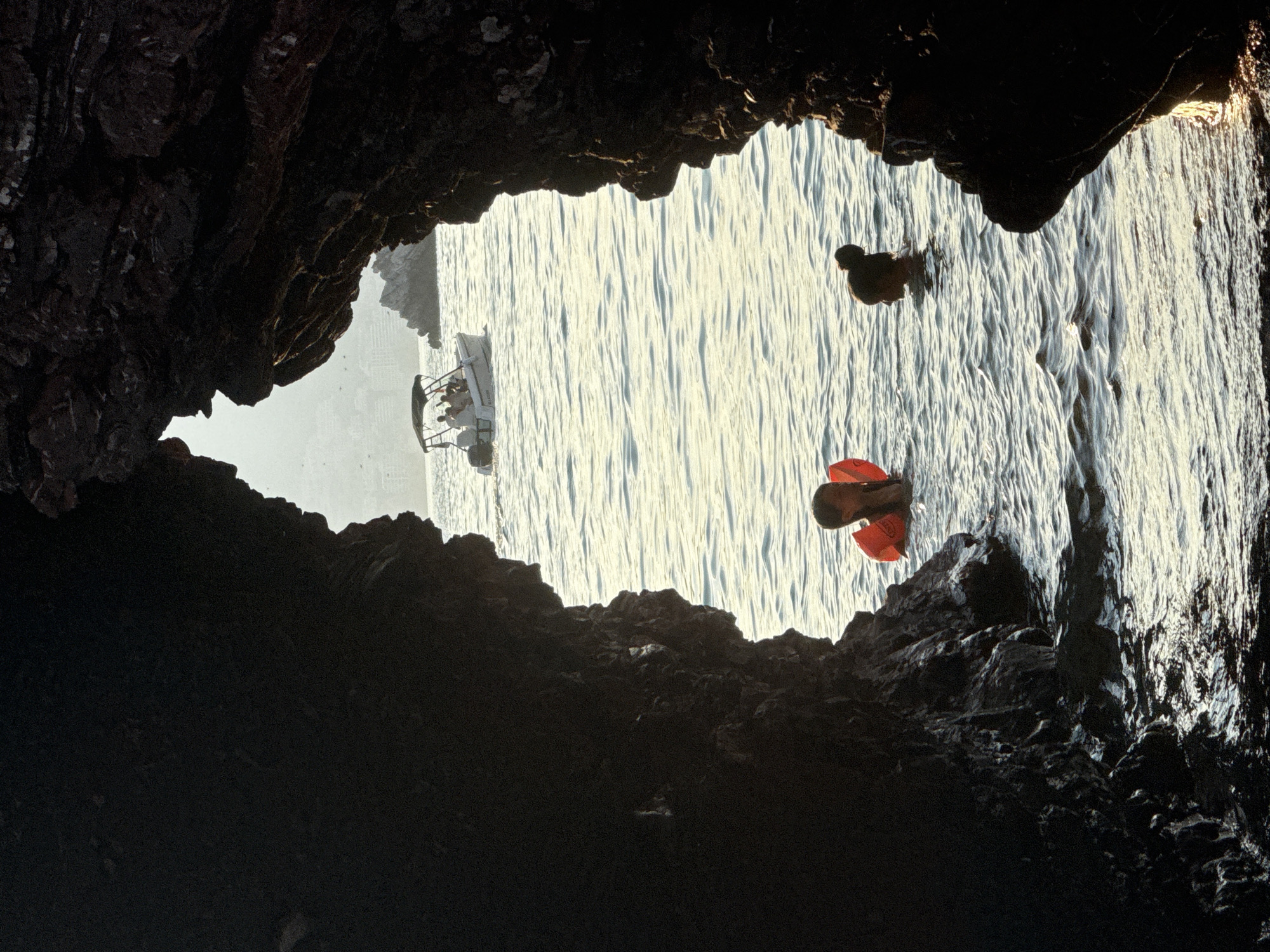 Cave openings, kayaks, and pebble beaches along the Budva coast