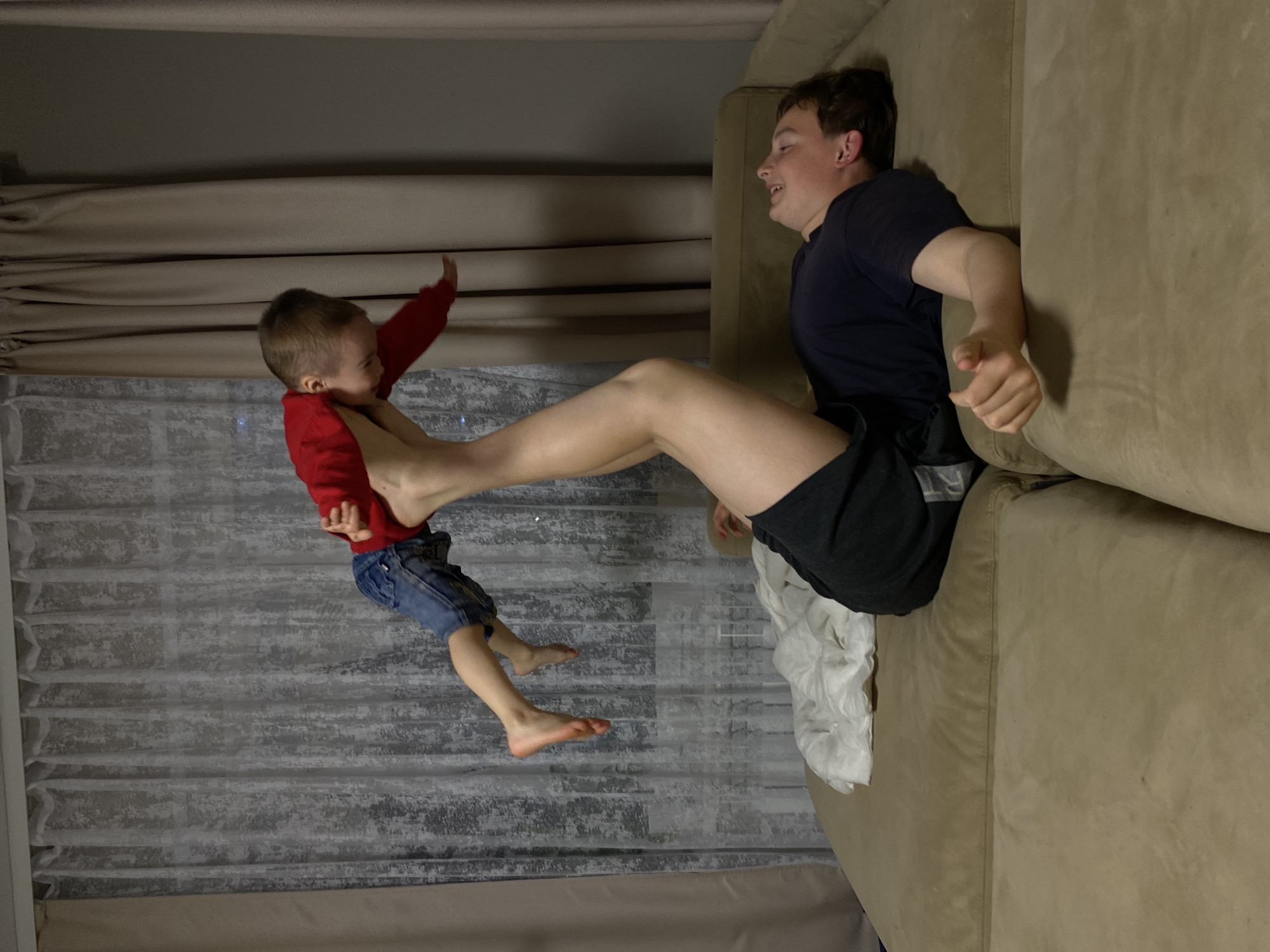 Adult and child captured playing on couch in Ольховка