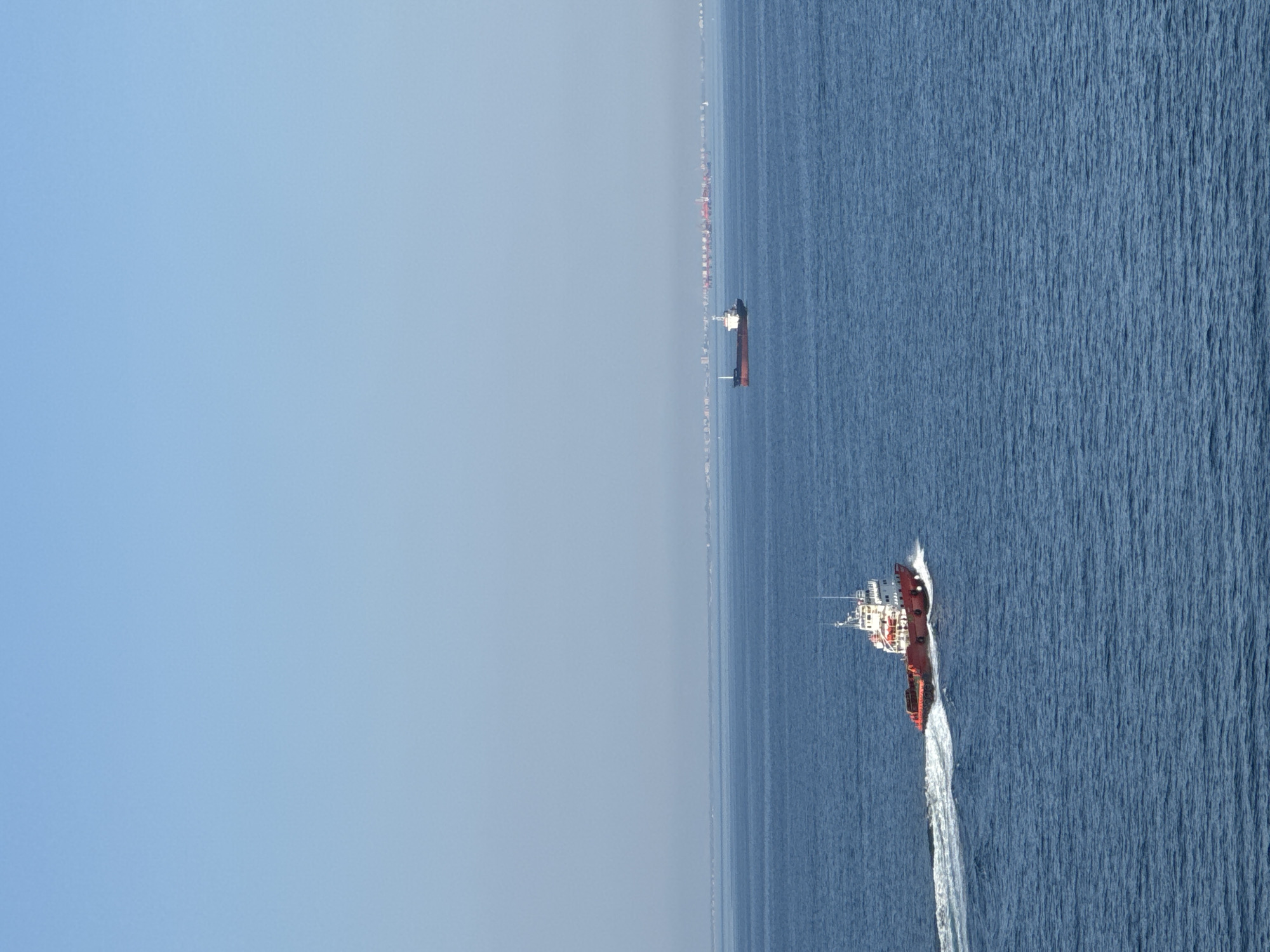 Tugboats working around an offshore oil rig in the Adriatic