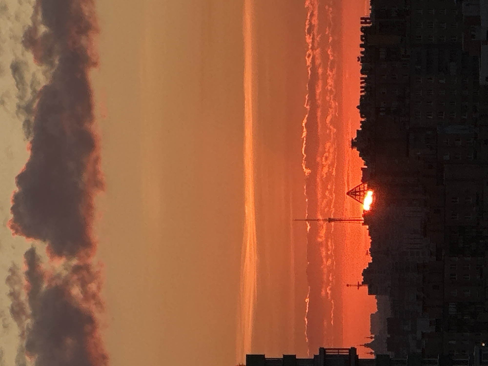 August sunset paints the Dnp Ryzhiki skyline in orange and pink